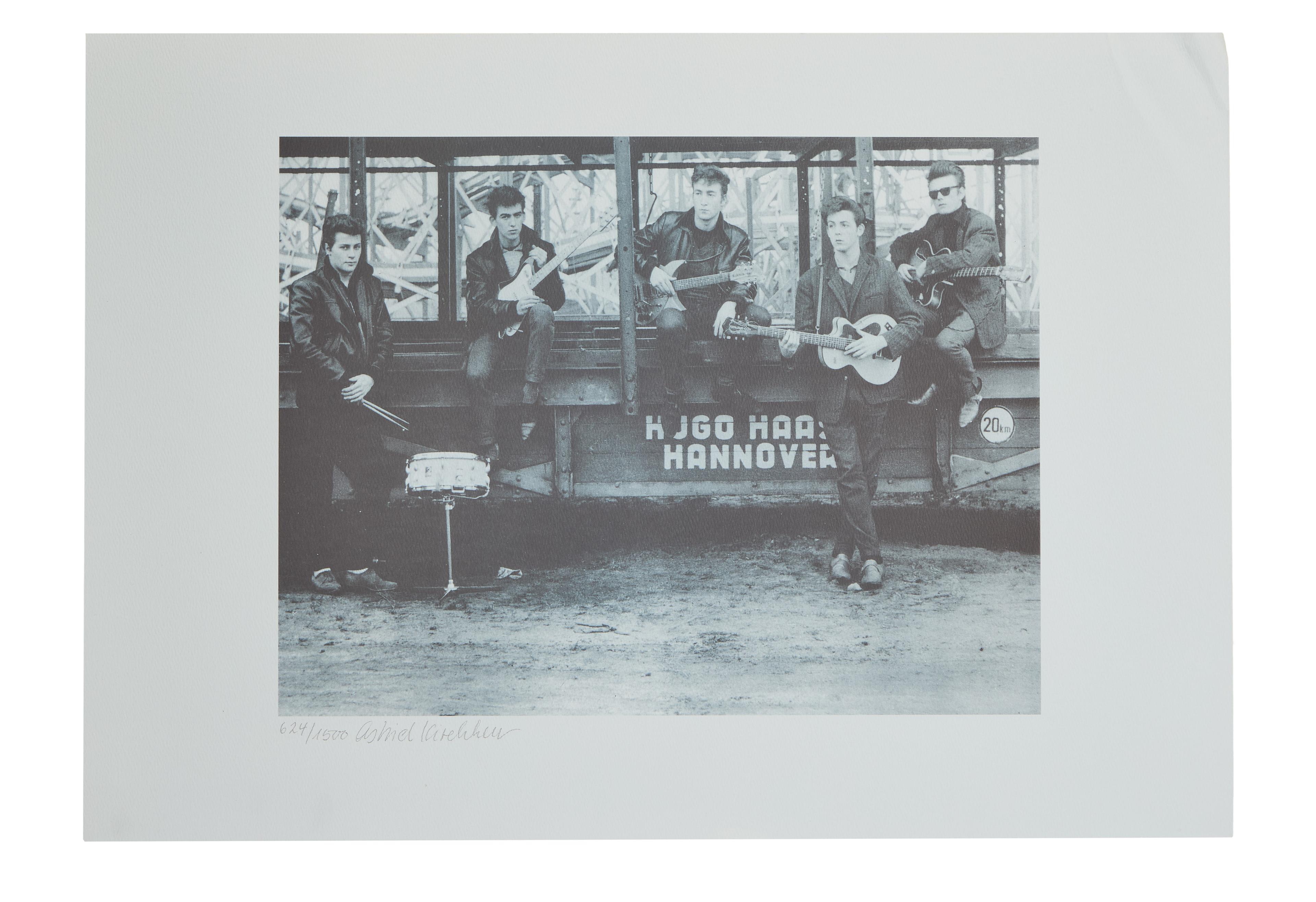 a black and white photo of a group of men playing guitars and drums .