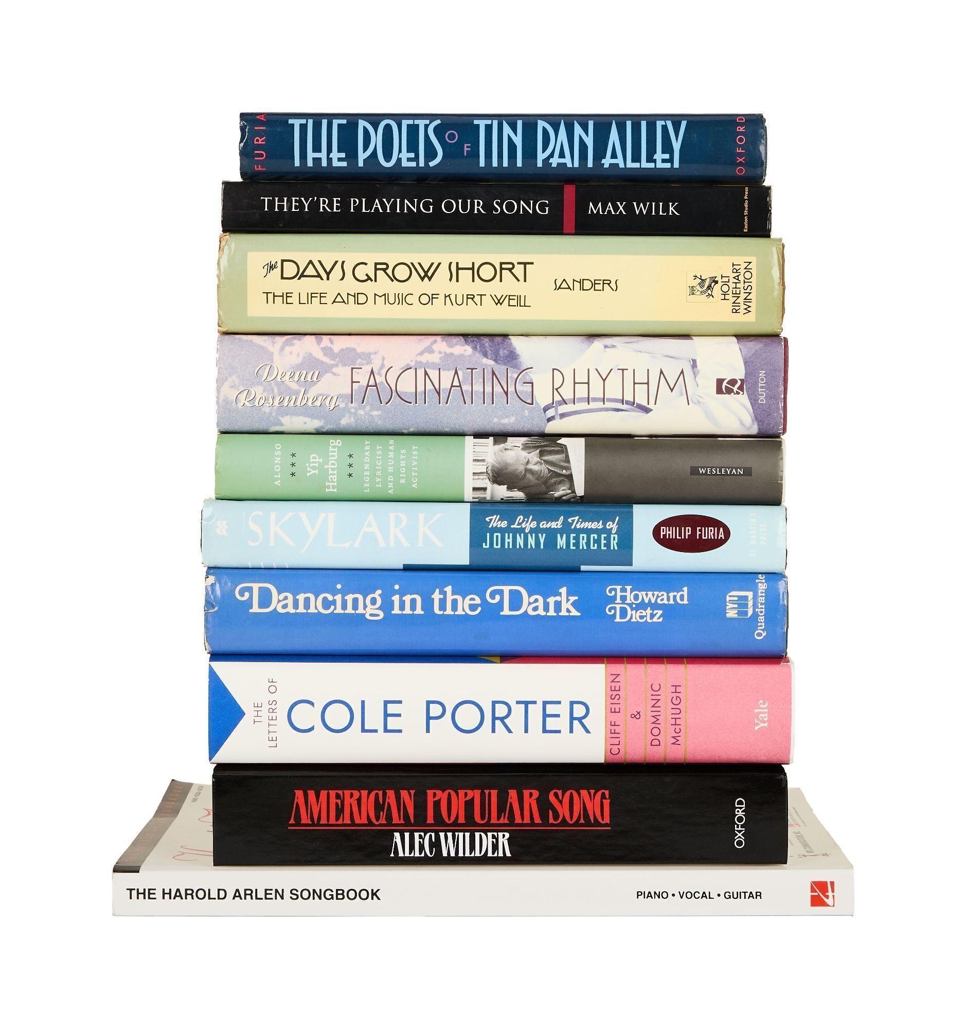 a stack of books including american popular song by alec wilder