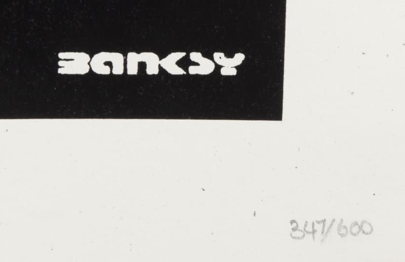 a banksy srt signature with 347 of 600 written in pencil