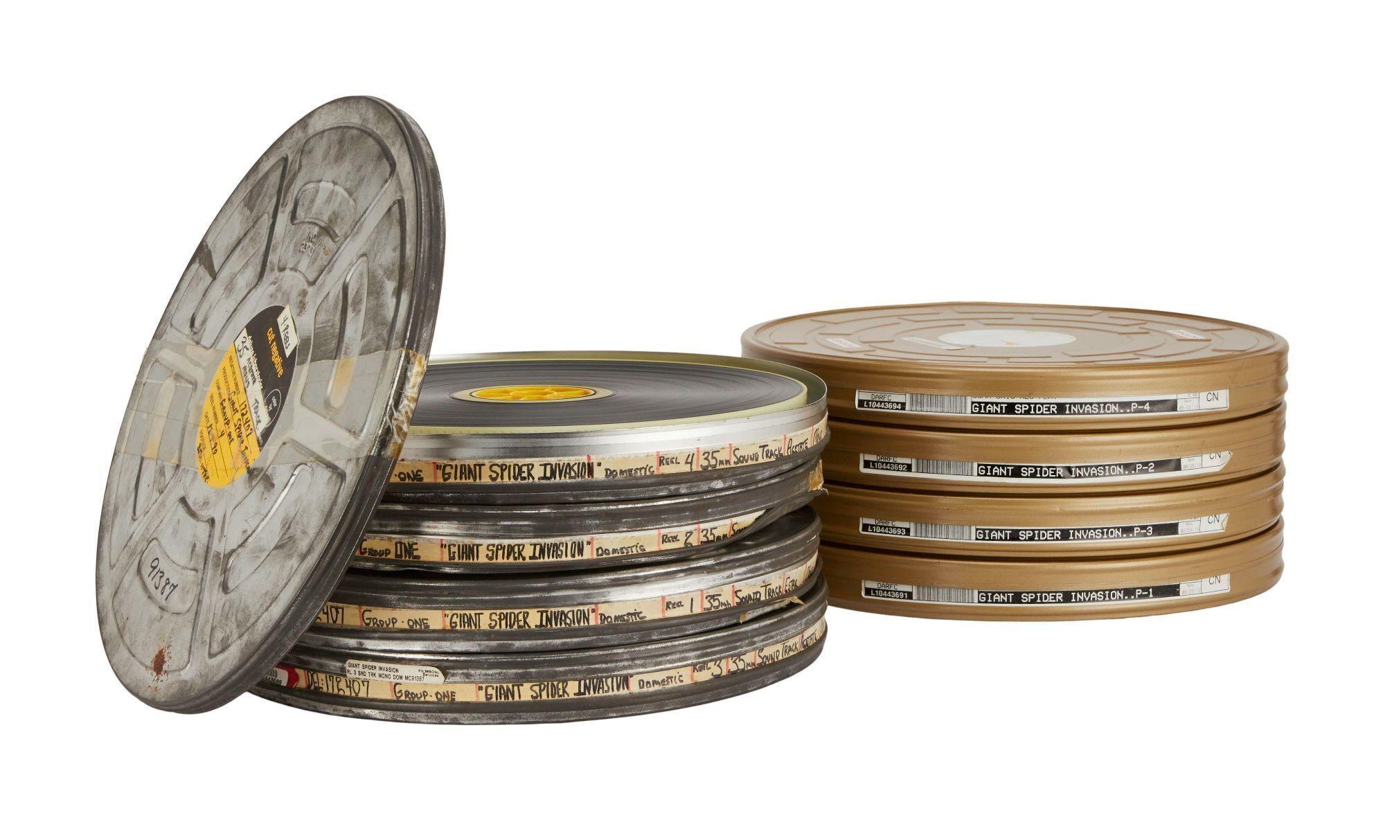 a stack of old film reels on a white background .