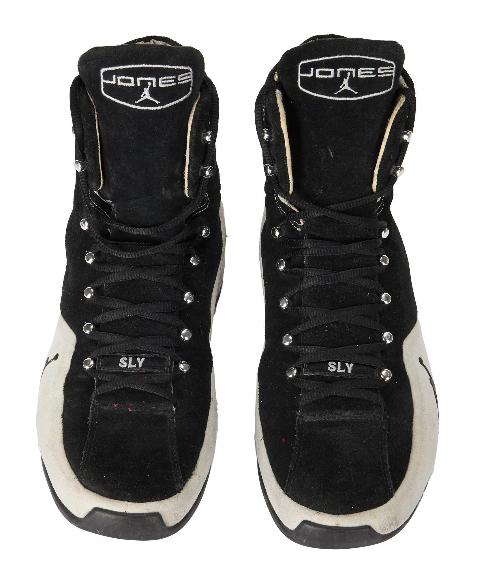 a pair of black and white jordan brand roy jones junior boxing shoes