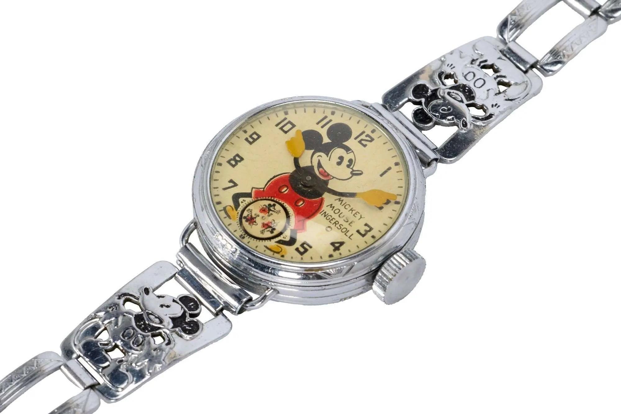 Lot #466. Whoopi Goldberg | Ingersoll 1933 Chicago World's Fair Mickey Mouse Wristwatch Vintage silver Mickey Mouse wristwatch with Mickey's arms as hands and decorative Mickey head links on the band.