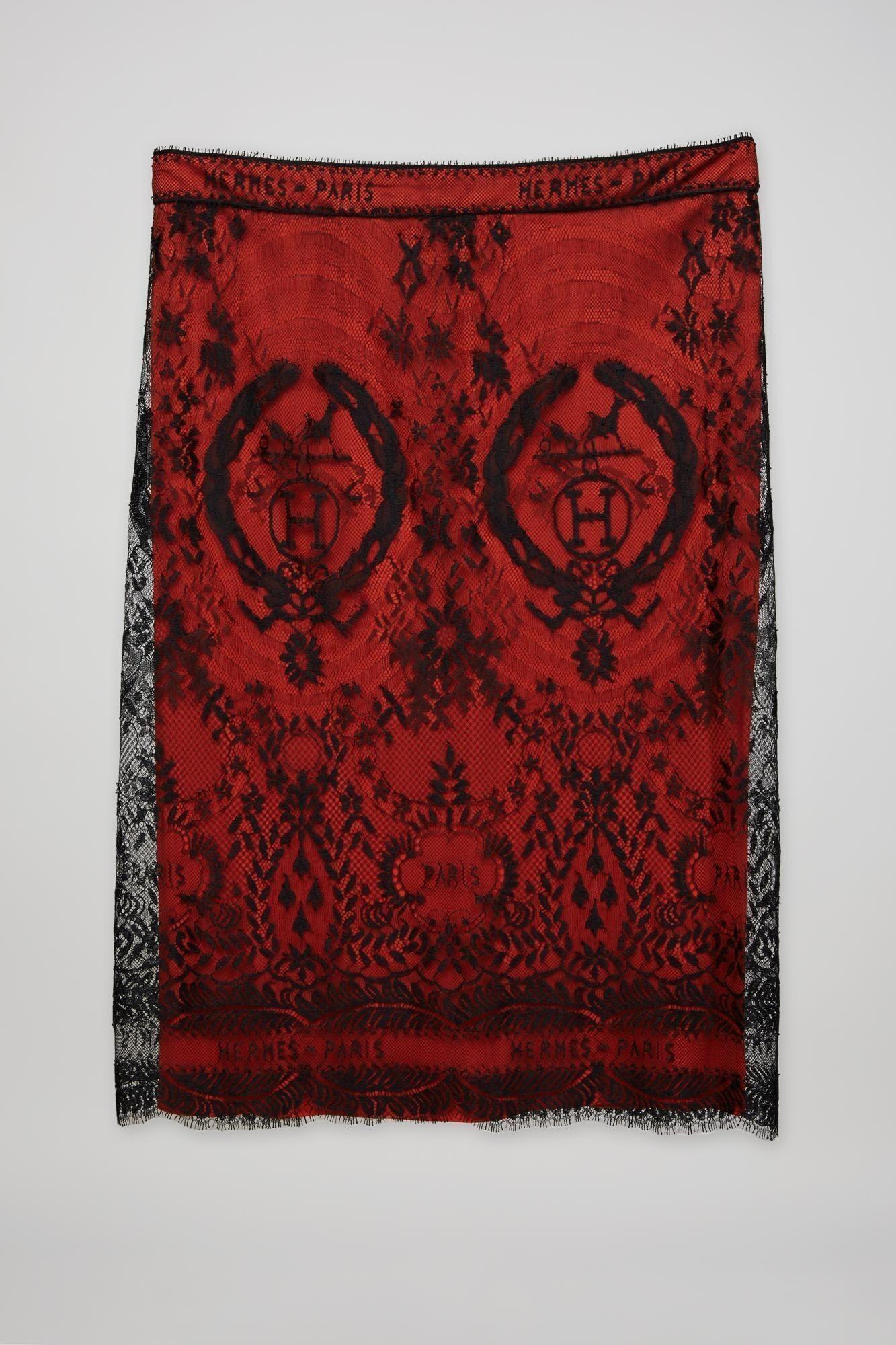 a red and black lace skirt with hermes paris written on it