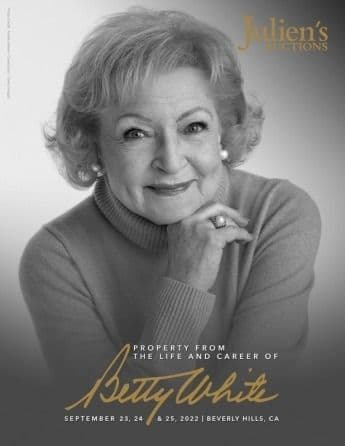 a black and white photo of betty white with her hand on her chin .