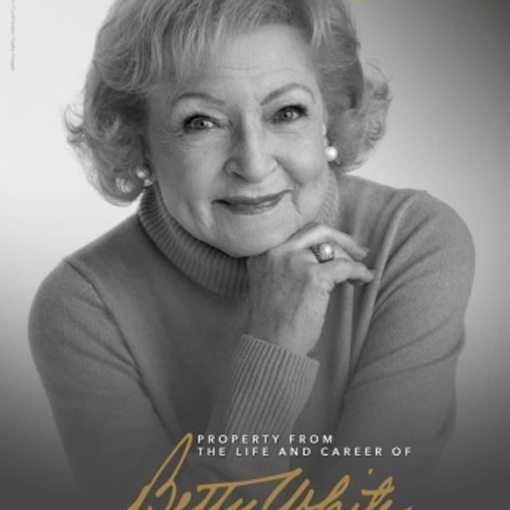 a black and white photo of betty white with her hand on her chin .