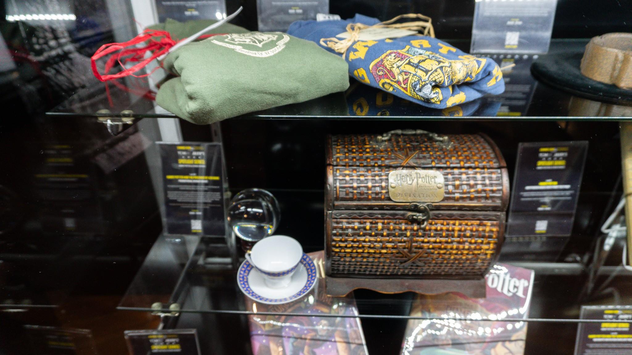 a display case filled with a variety of harry potter items .