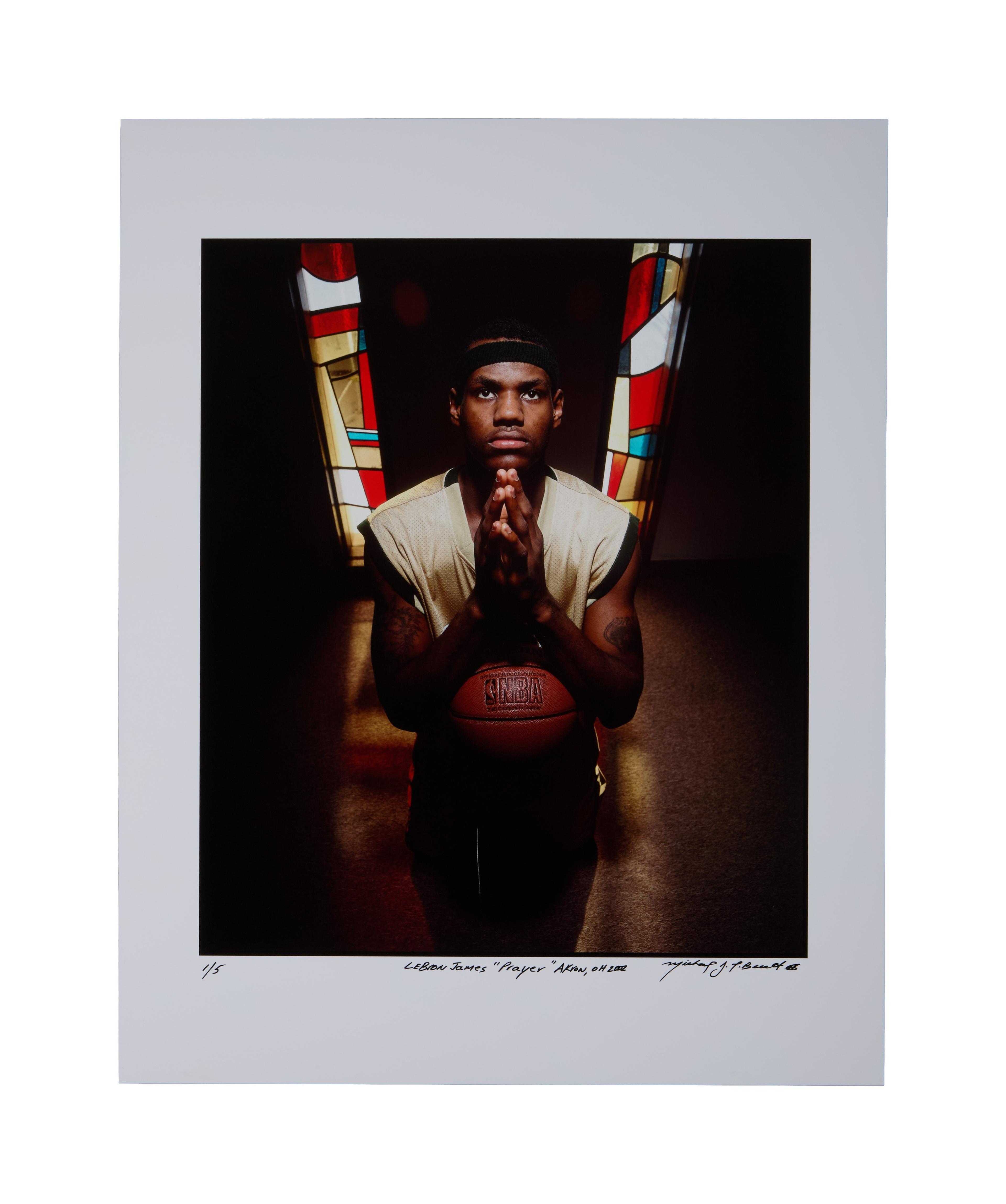 a man is holding a basketball in his hands in front of a stained glass window .