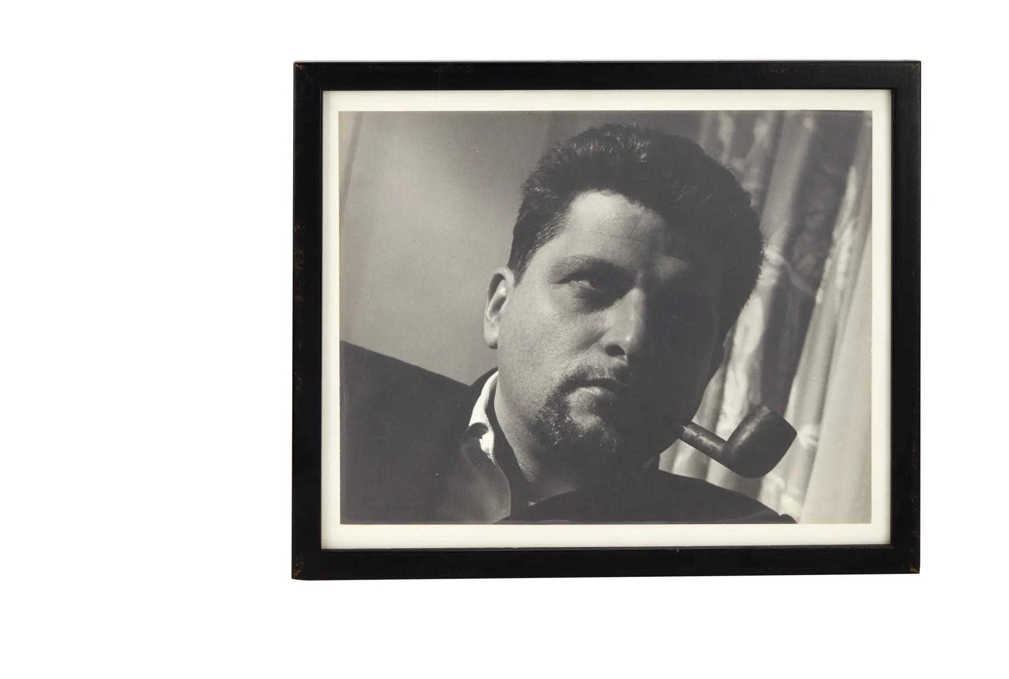 a black and white photo of paddy chayefsky smoking a tobacco pipe