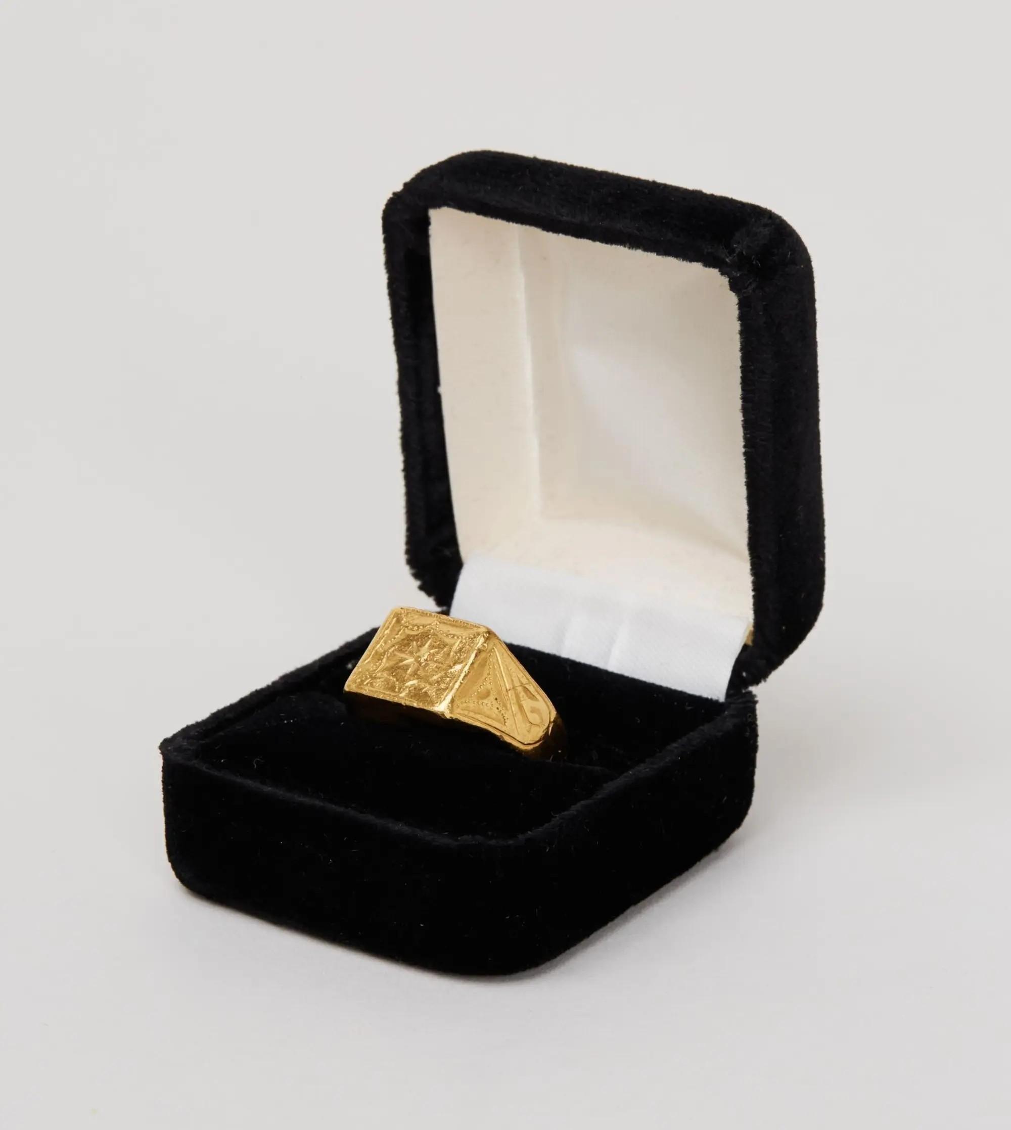 a gold ring in a black box
