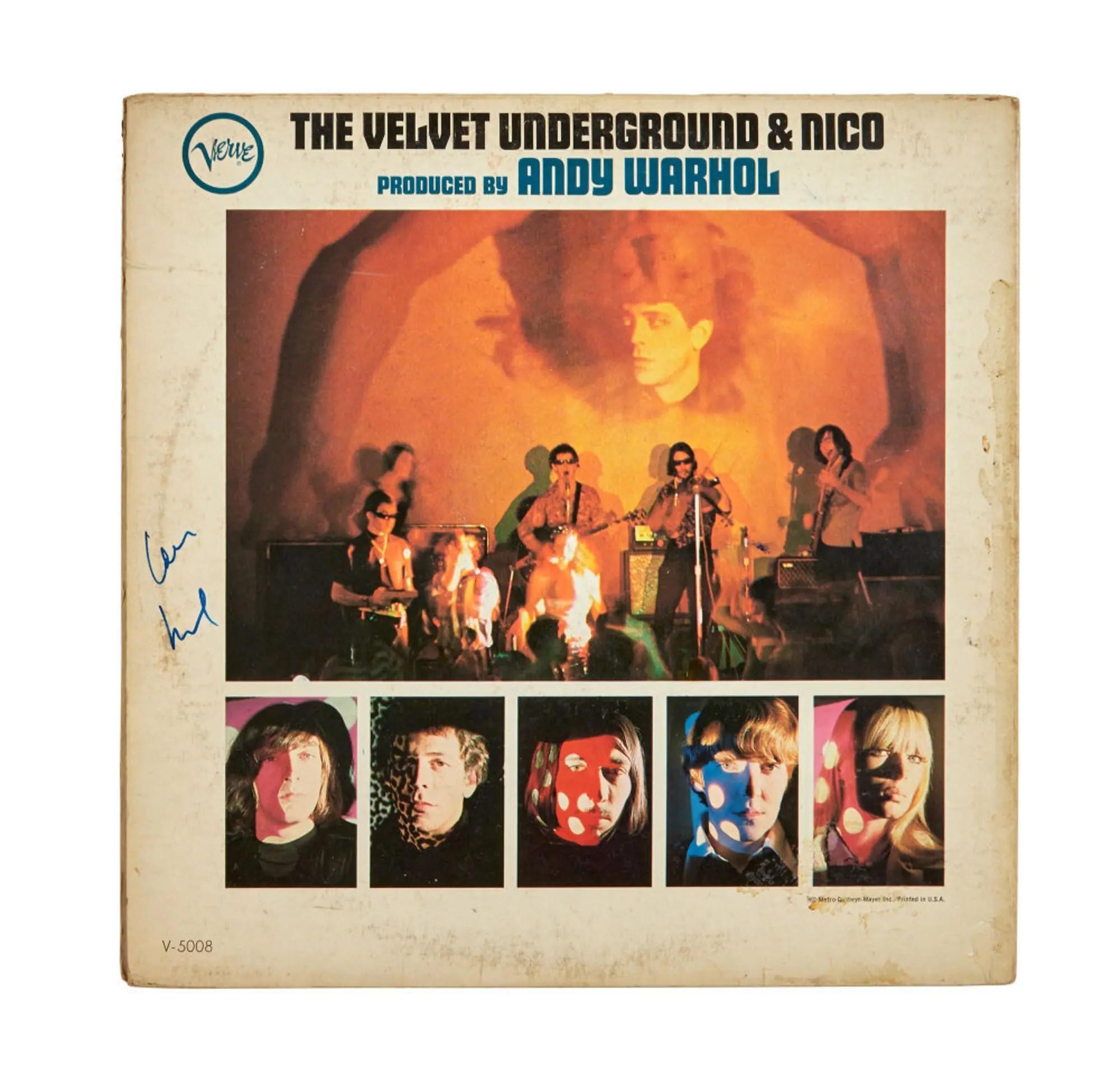 Front cover of The Velvet Underground & Nico album, produced by Andy Warhol, showing a band performing live with a large projected face and five individual portraits below.