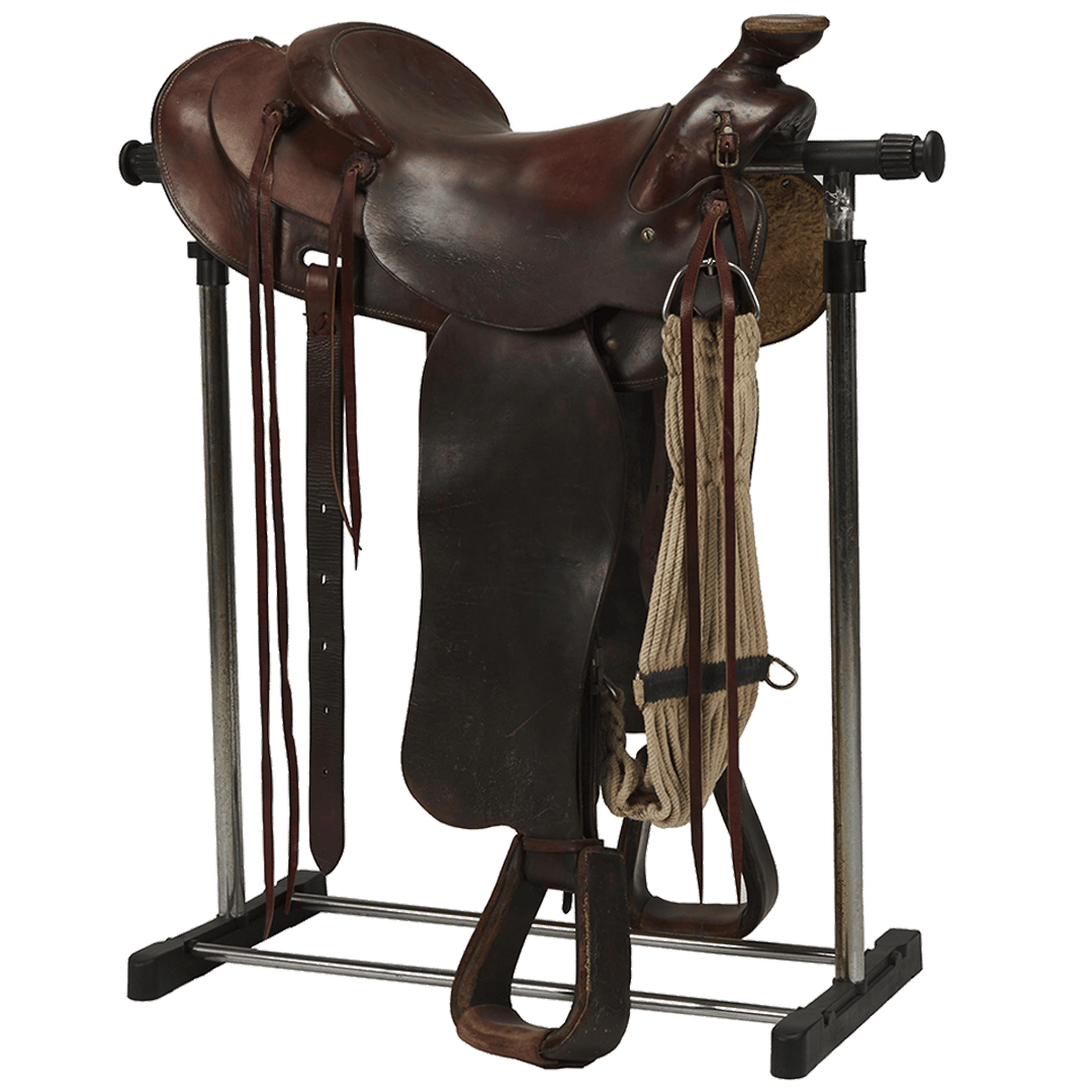 a brown saddle is sitting on a metal stand
