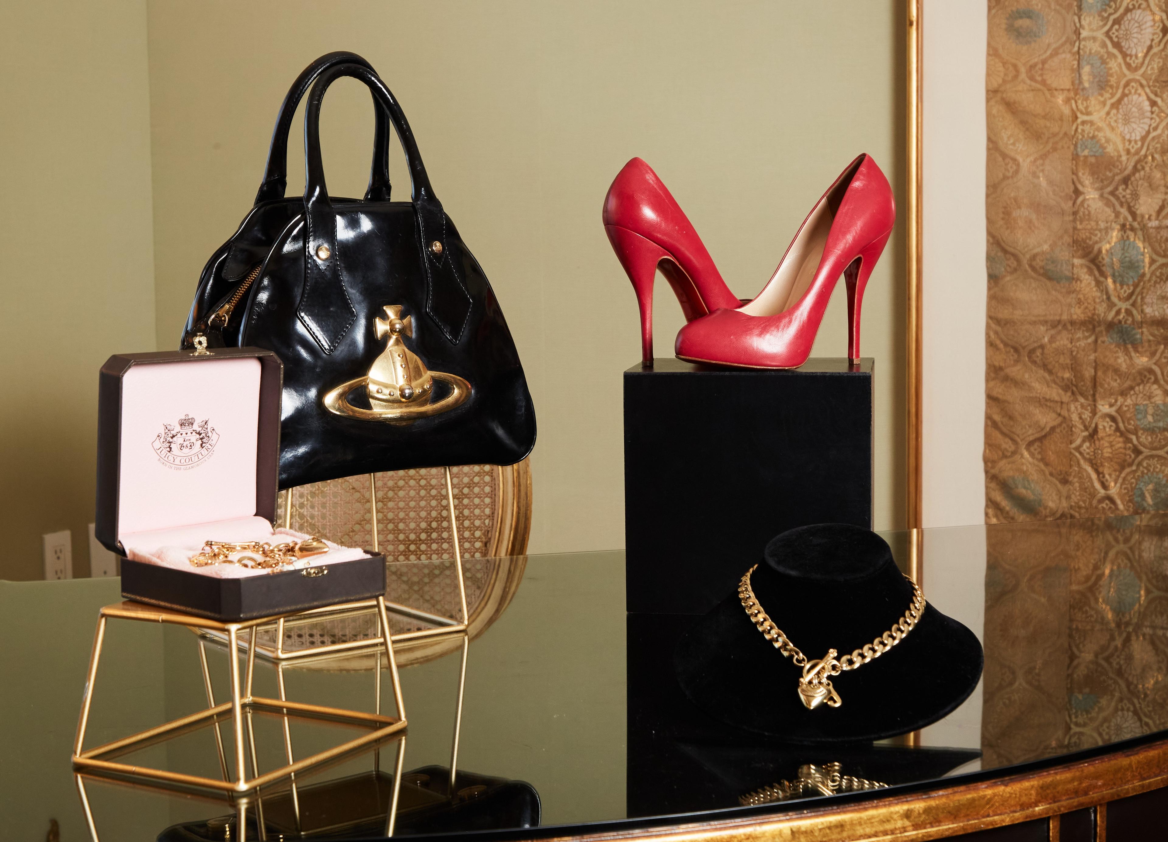 a table with a purse , necklace , and shoes on it .