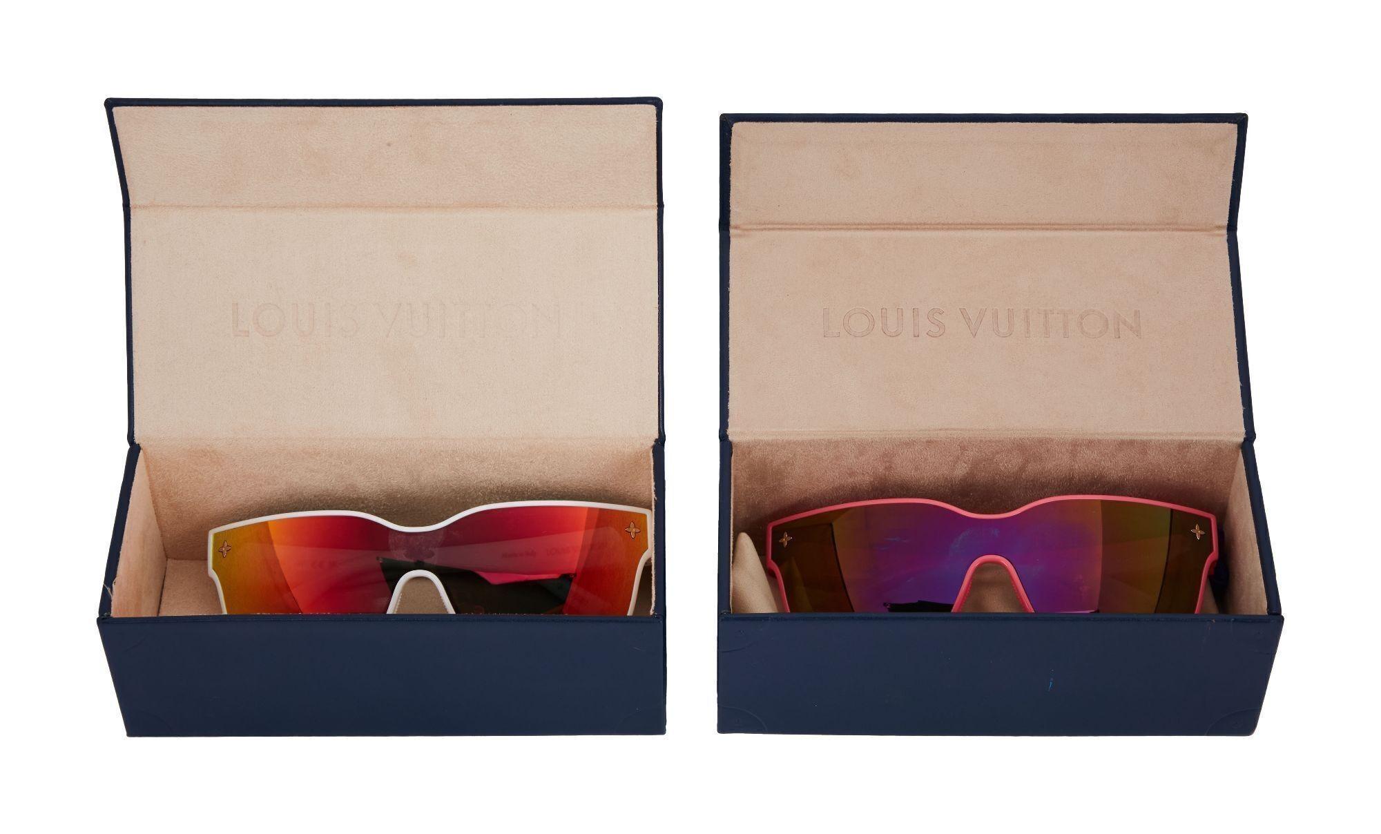 Lot #477. Angus Cloud | Louis Vuitton Sunglasses a pair of sunglasses is sitting in a blue box .