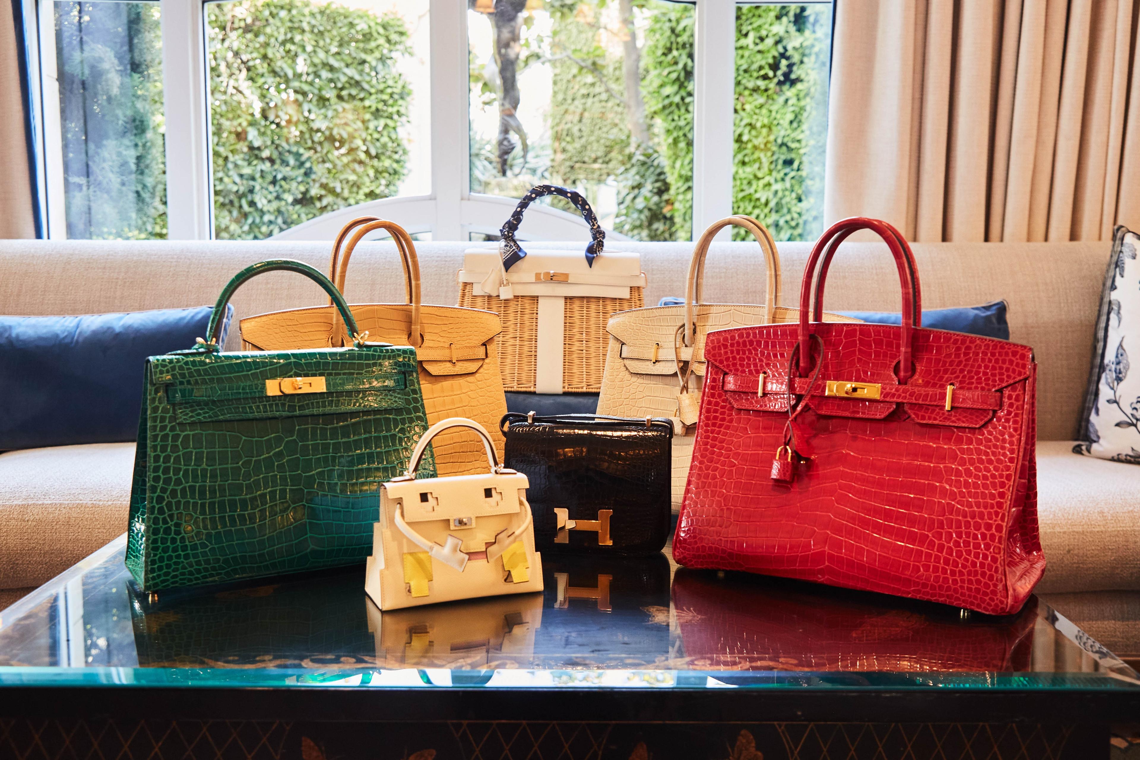 a group of handbags are sitting on top of a glass table .