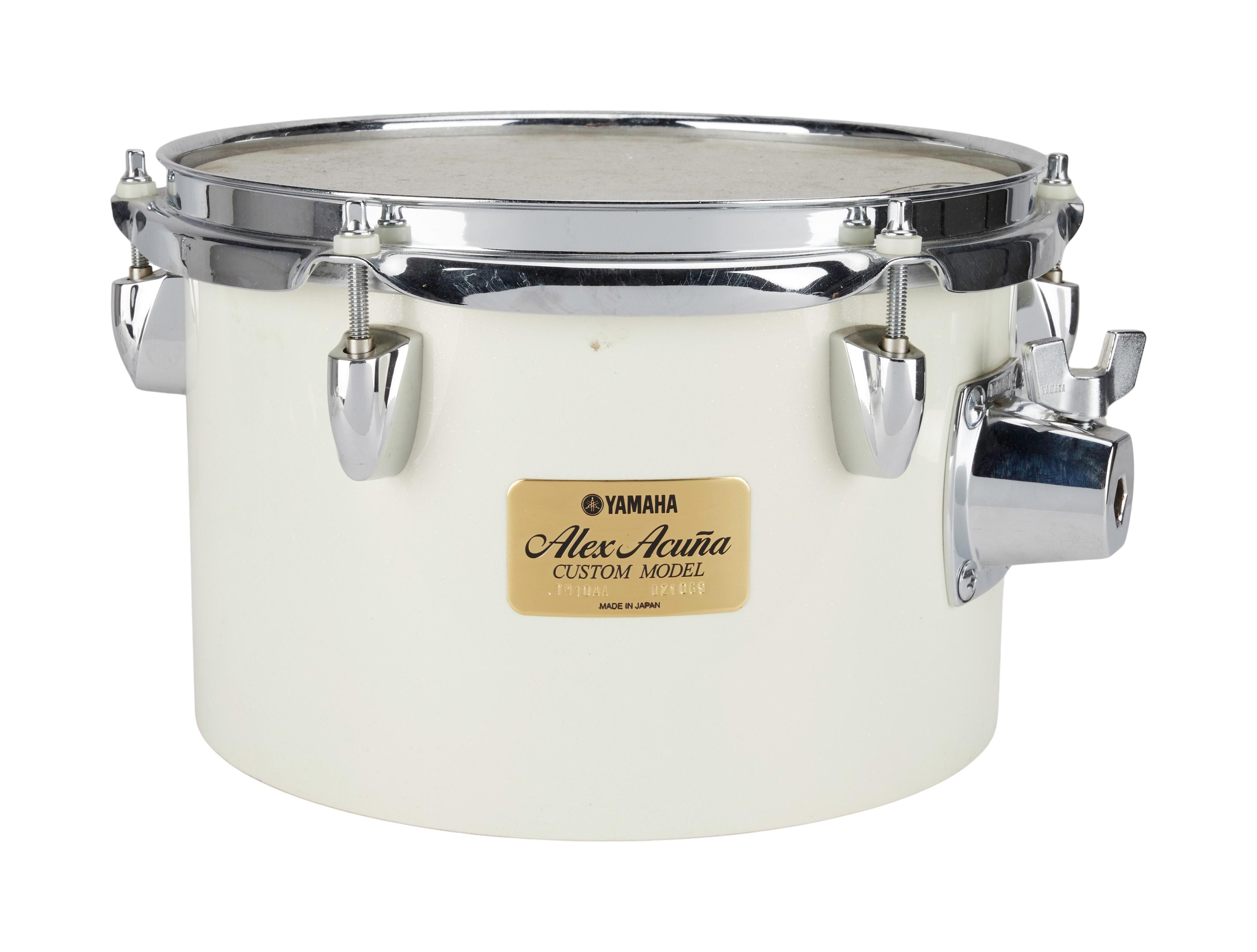 a white yamaha alex acura custom model snare drum on a white background .