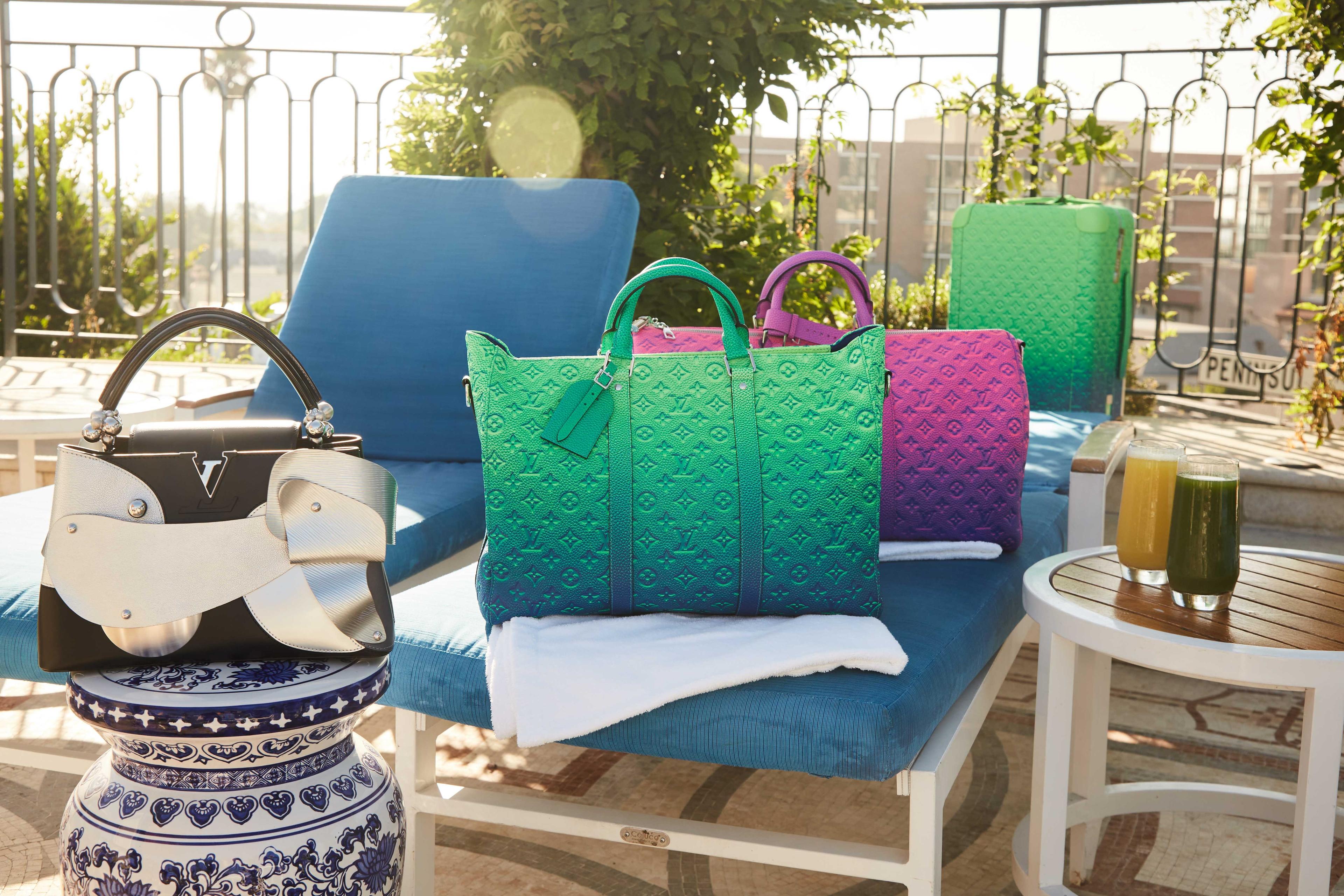 a group of louis vuitton bags are sitting on a patio chair .