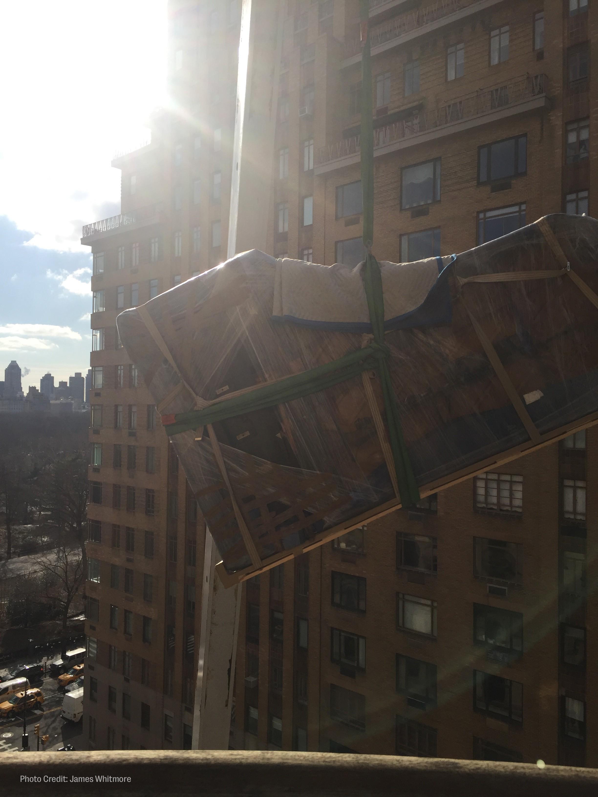 workers hoist roberta flack's piano out of her new york city apartment window.