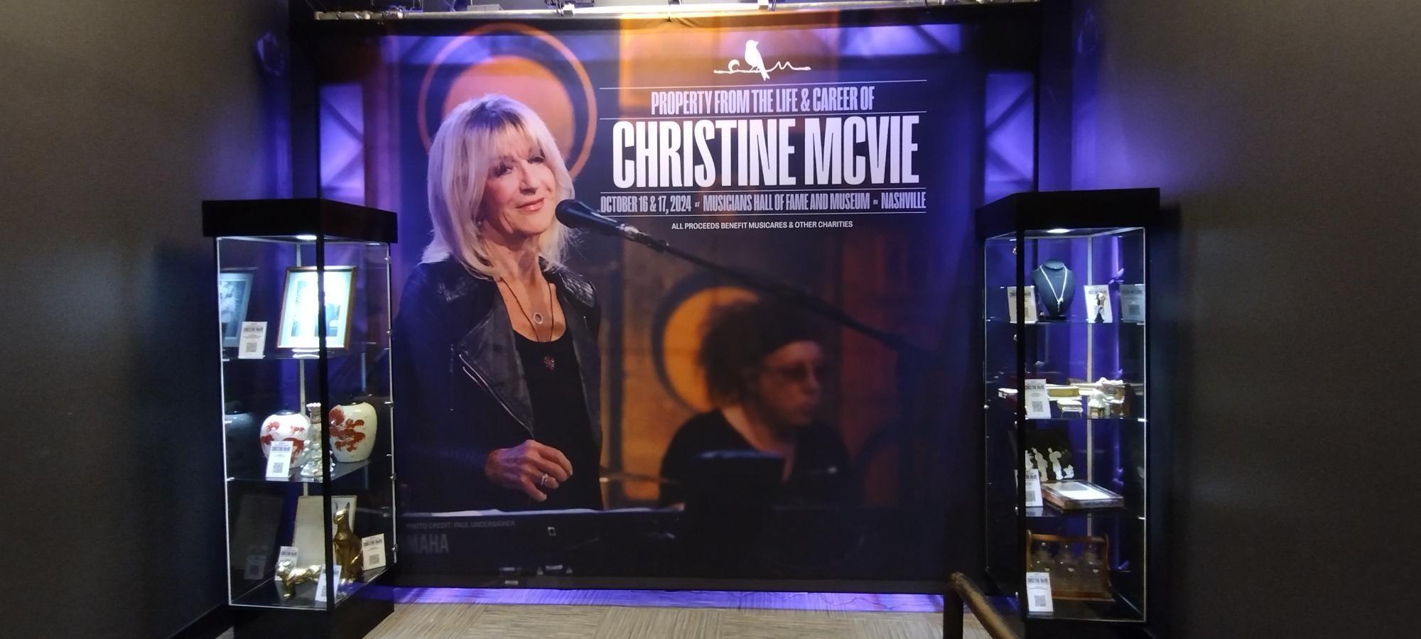 a large poster of christine movie is hanging on a wall .