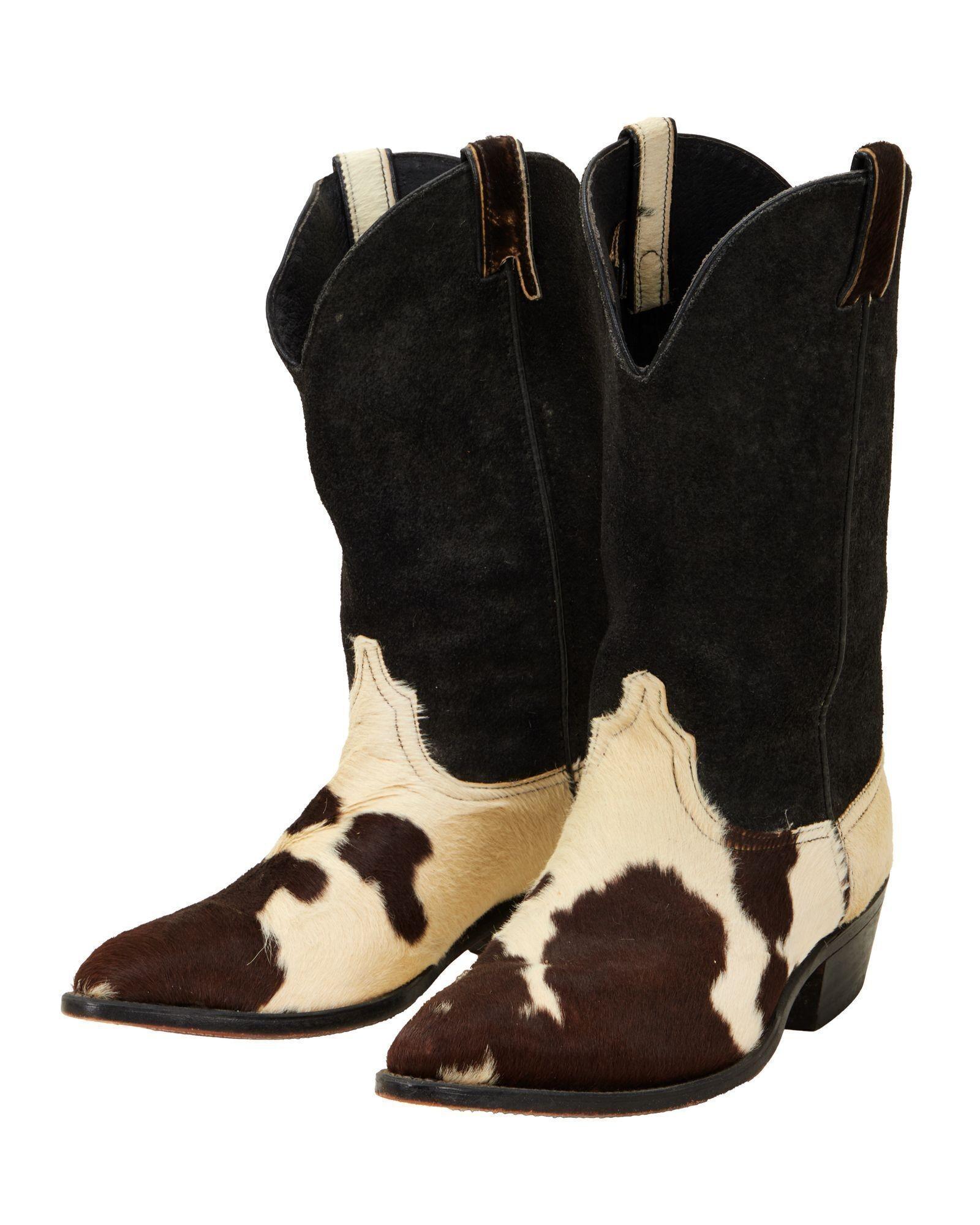 Lot #322. Burt Reynolds | Cowhide Cowboy Boots a pair of black and white cow print cowboy boots