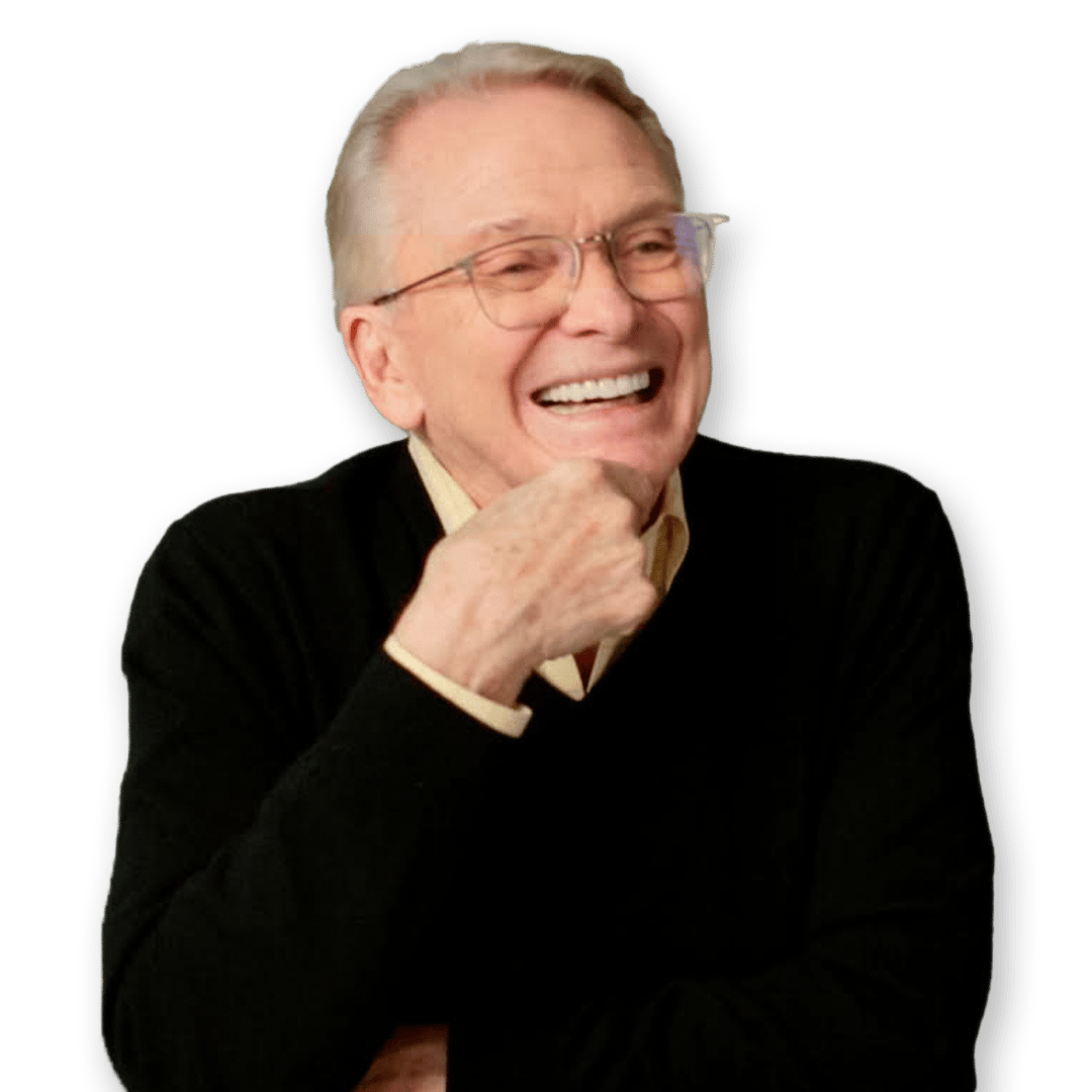 a man wearing glasses and a black sweater is laughing