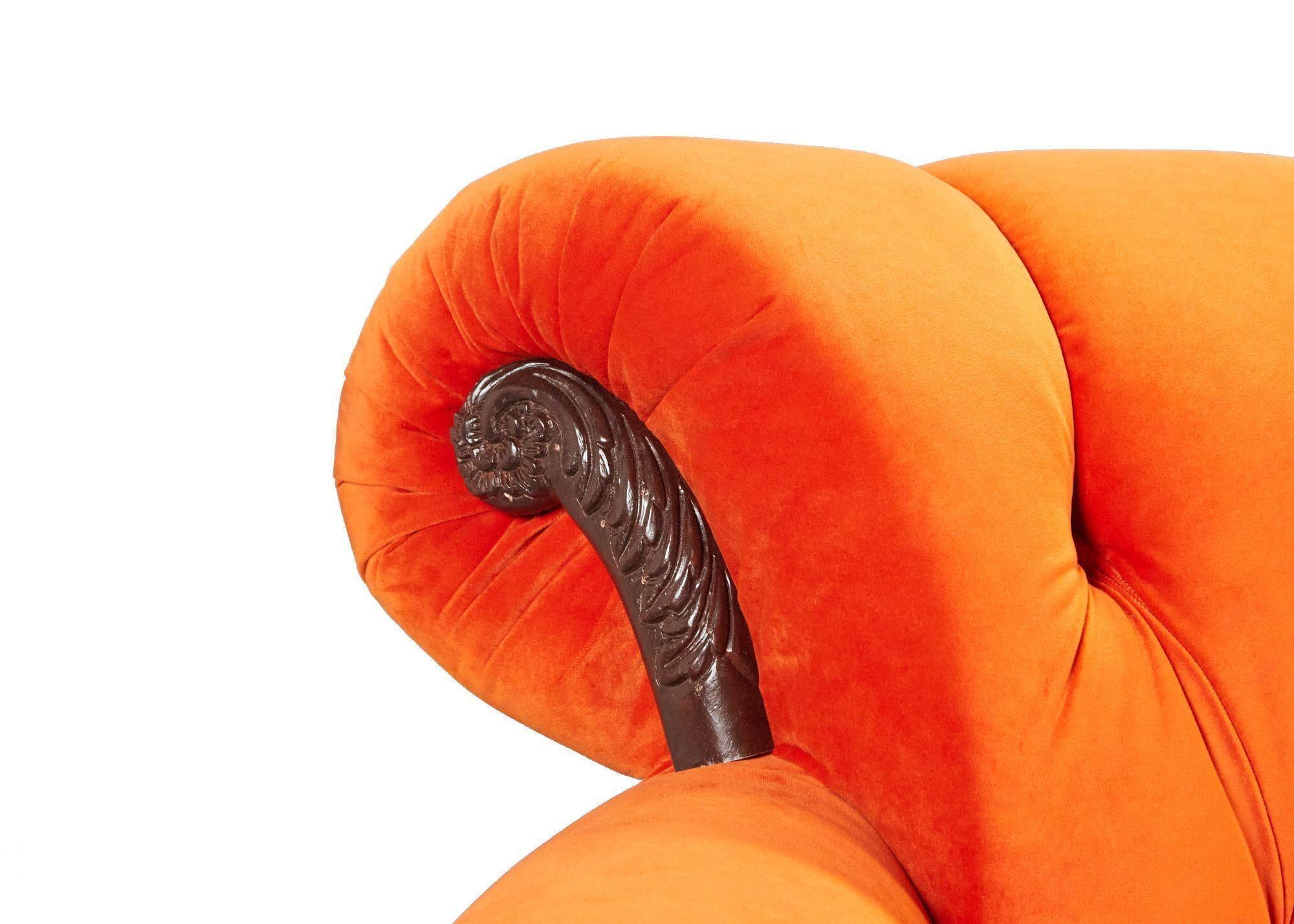 a close up of the arm of an orange couch on a white background .