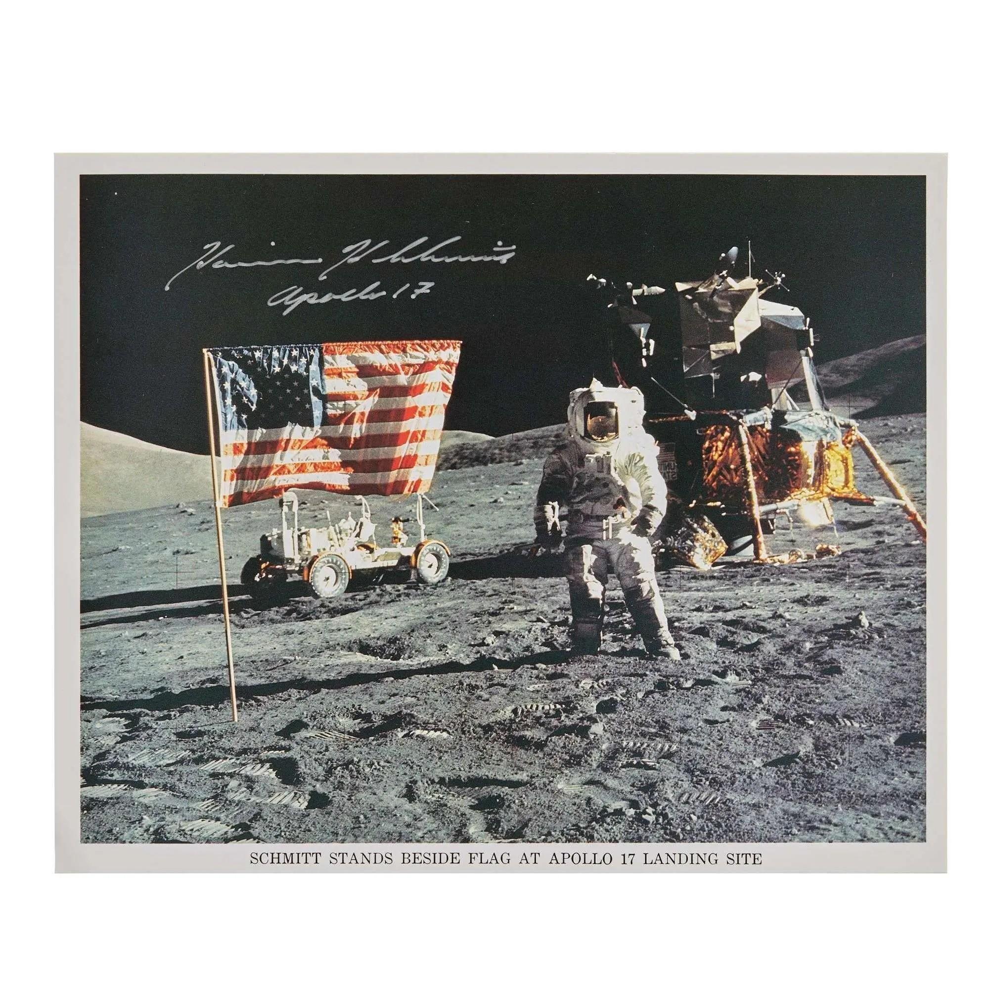 Signed photo of astronaut Harrison Schmitt standing on the Moon beside an American flag, with a lunar lander and rover from the Apollo 17 mission.