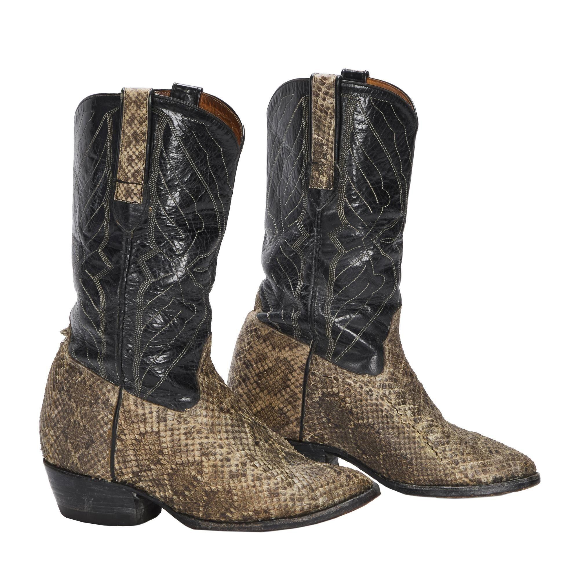 Lot #319. Burt Reynolds | Snakeskin Cowboy Boots a pair of snakeskin cowboy boots on a white background .