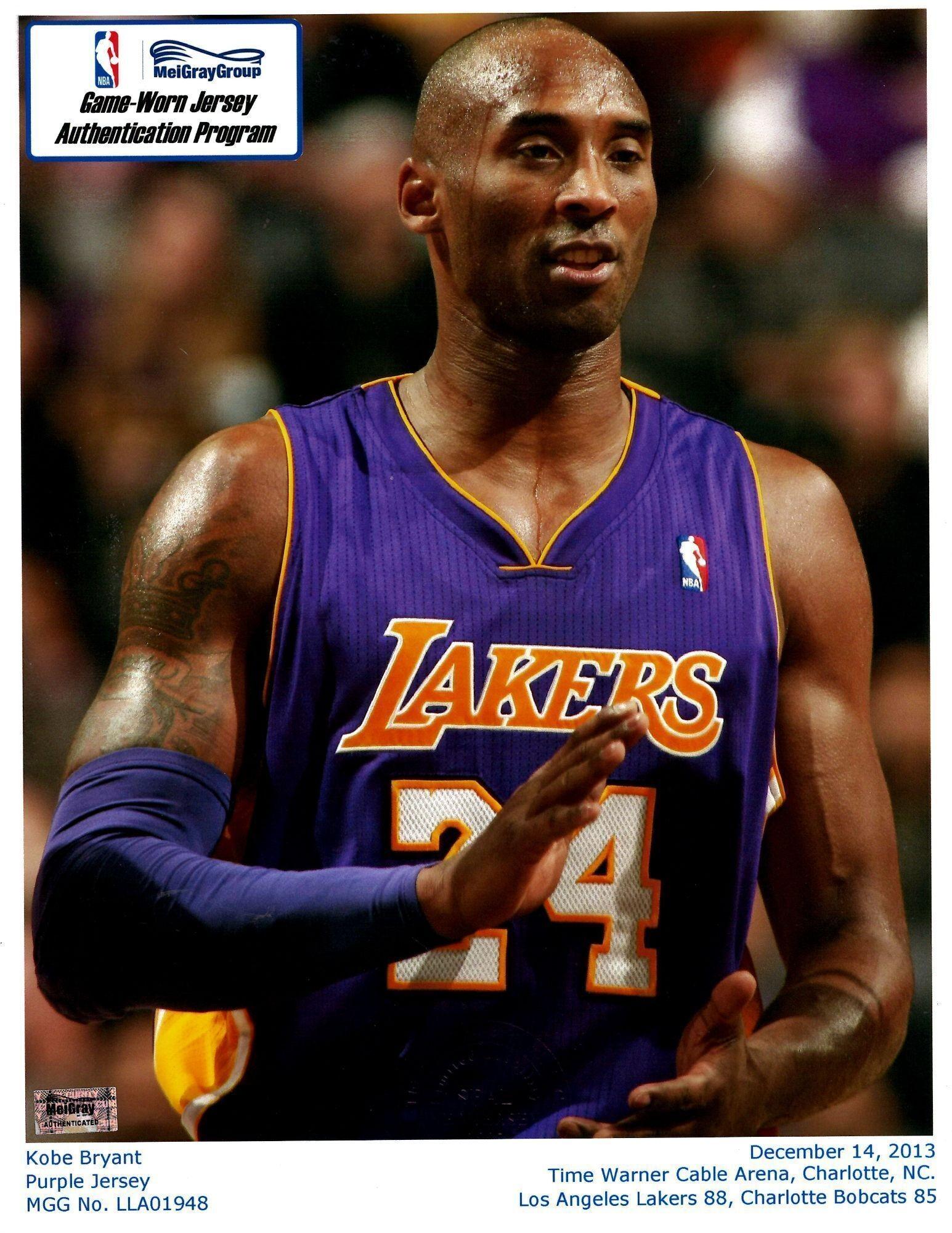 kobe bryant is wearing a purple lakers jersey