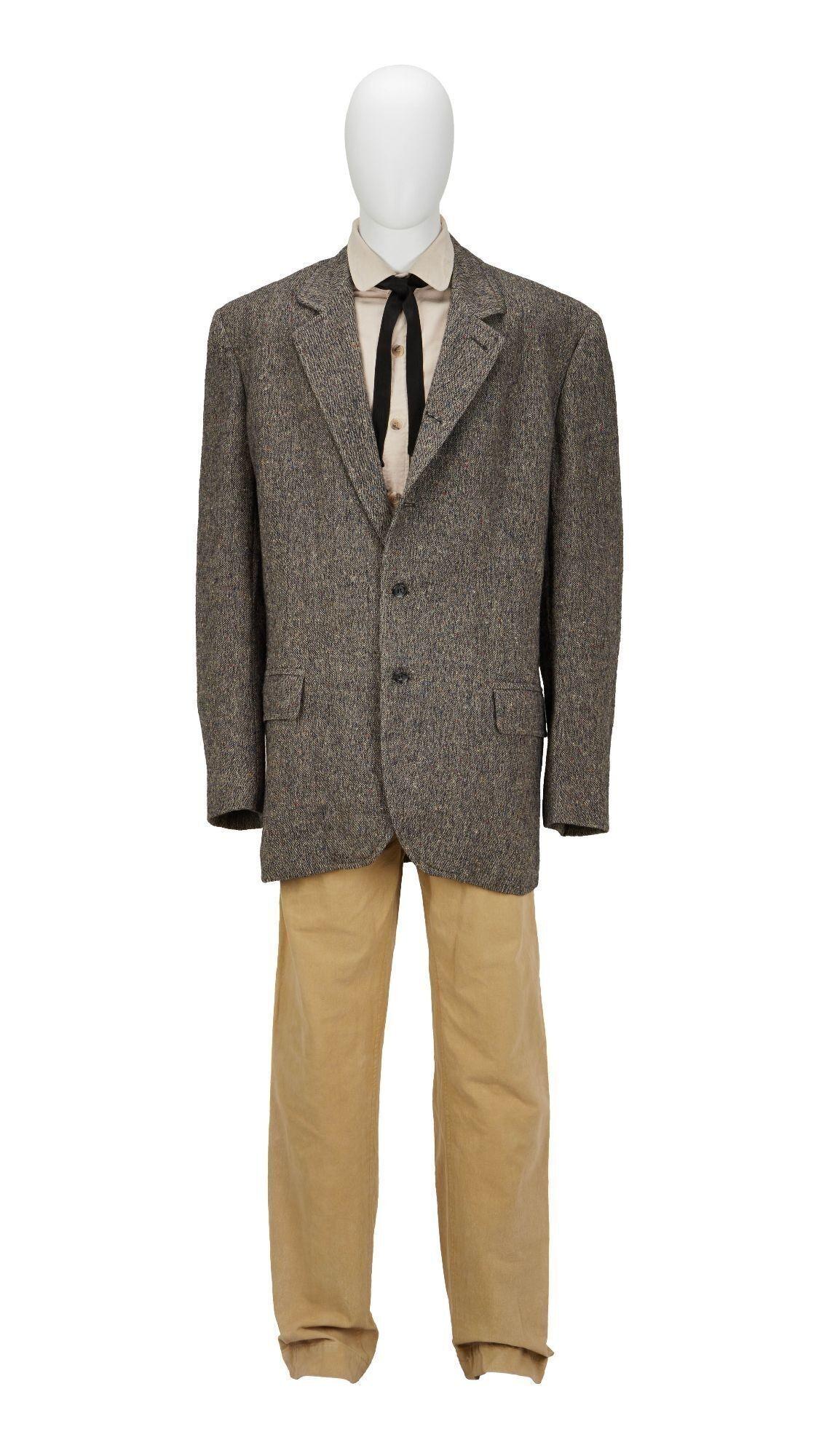a mannequin wearing a grey jacket and tan pants