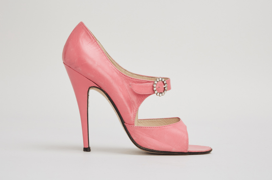 a pair of pink high heels with a rhinestone buckle