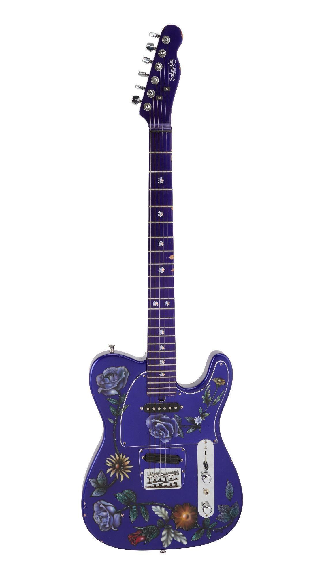 a purple electric guitar with flowers painted on it
