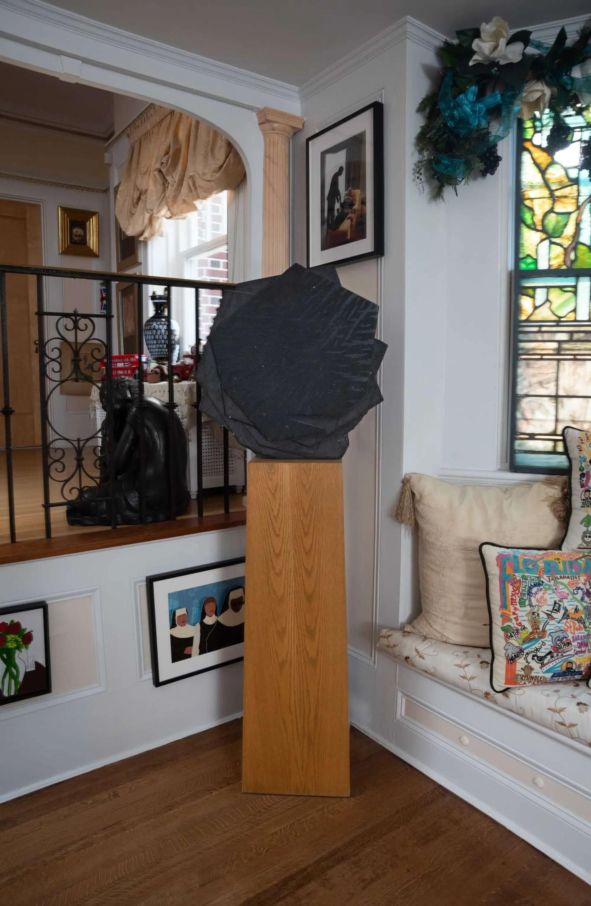Lot #264. Whoopi Goldberg | Stone Sculpture on Wood Pedestal a black Stone Sculpture on Wood Pedestal in the home of whoopi goldberg