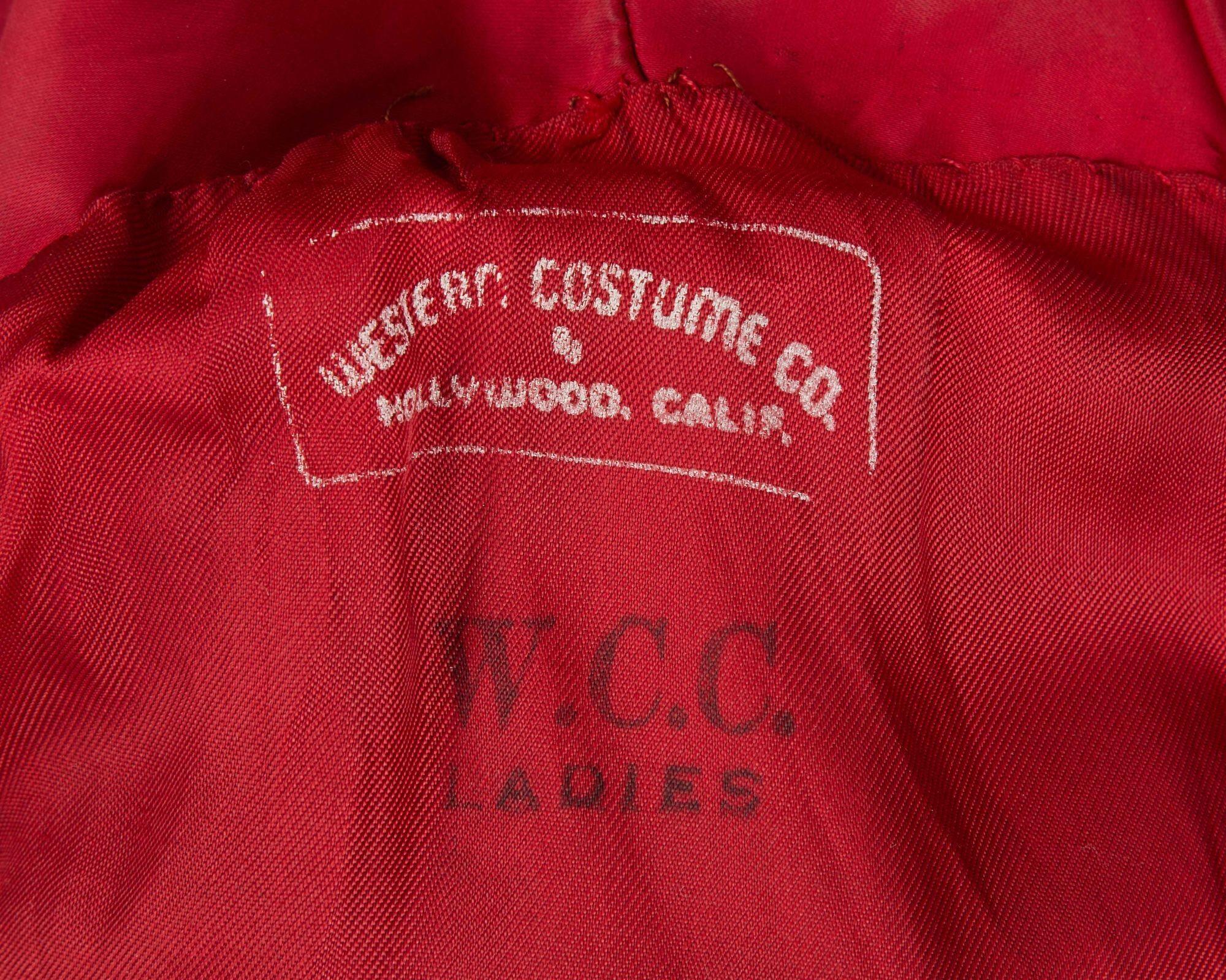 a close up of the inside of a red jacket with the words `` western costume co. '' written on it .