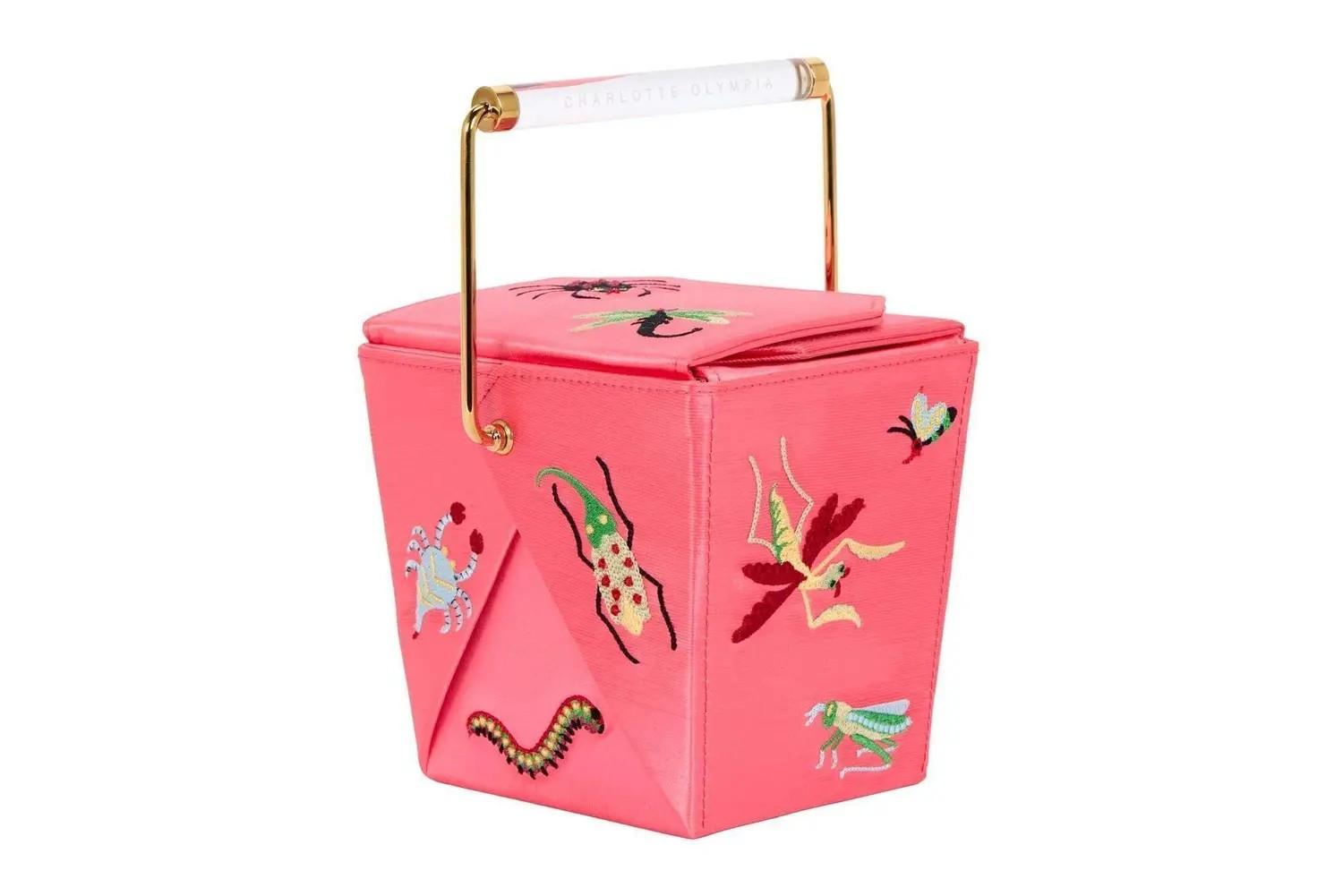 A pink Charlotte Olympia handbag shaped like a Chinese takeout box, embroidered with colorful insects.
