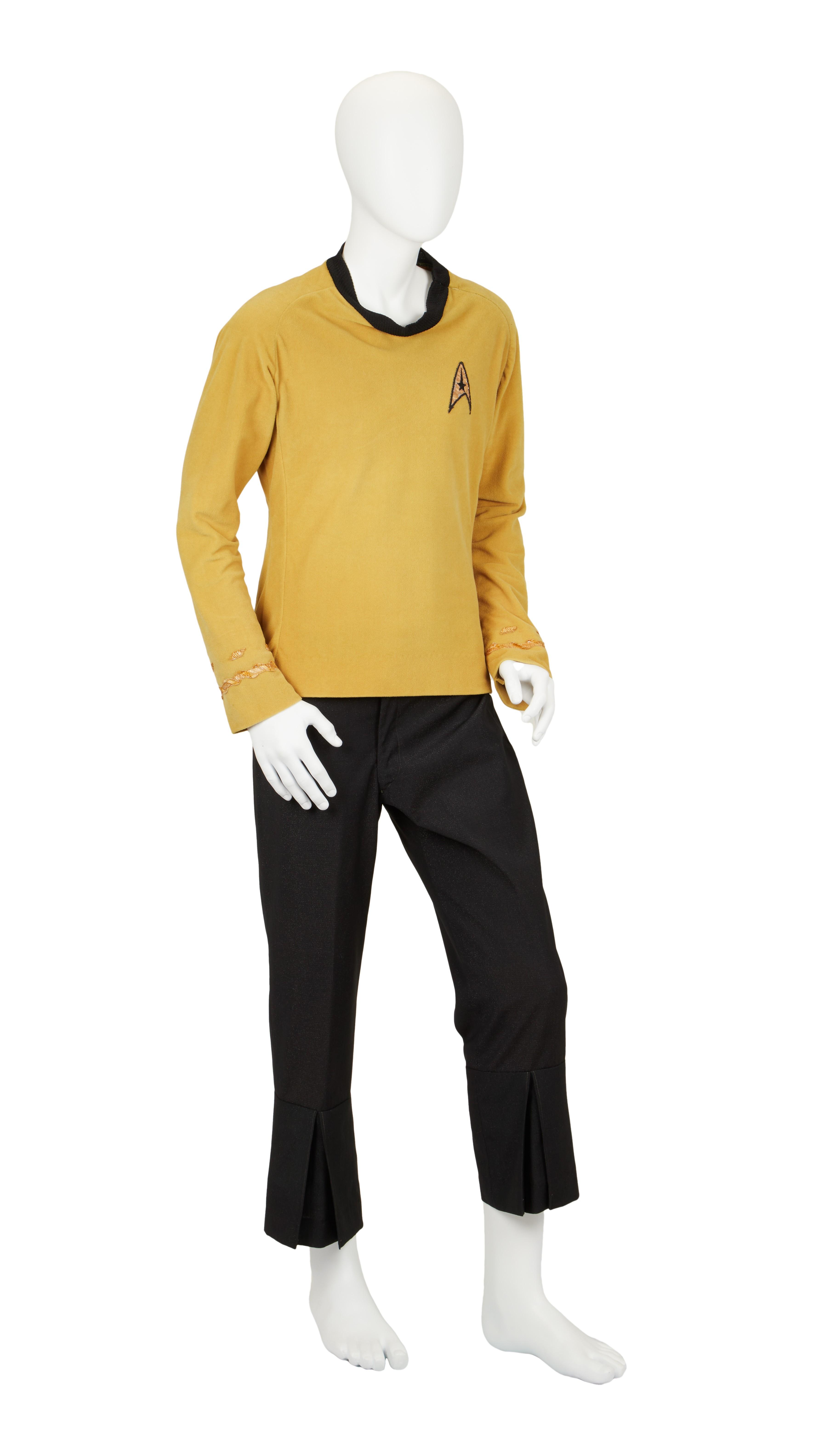 a mannequin is wearing a yellow shirt and black pants