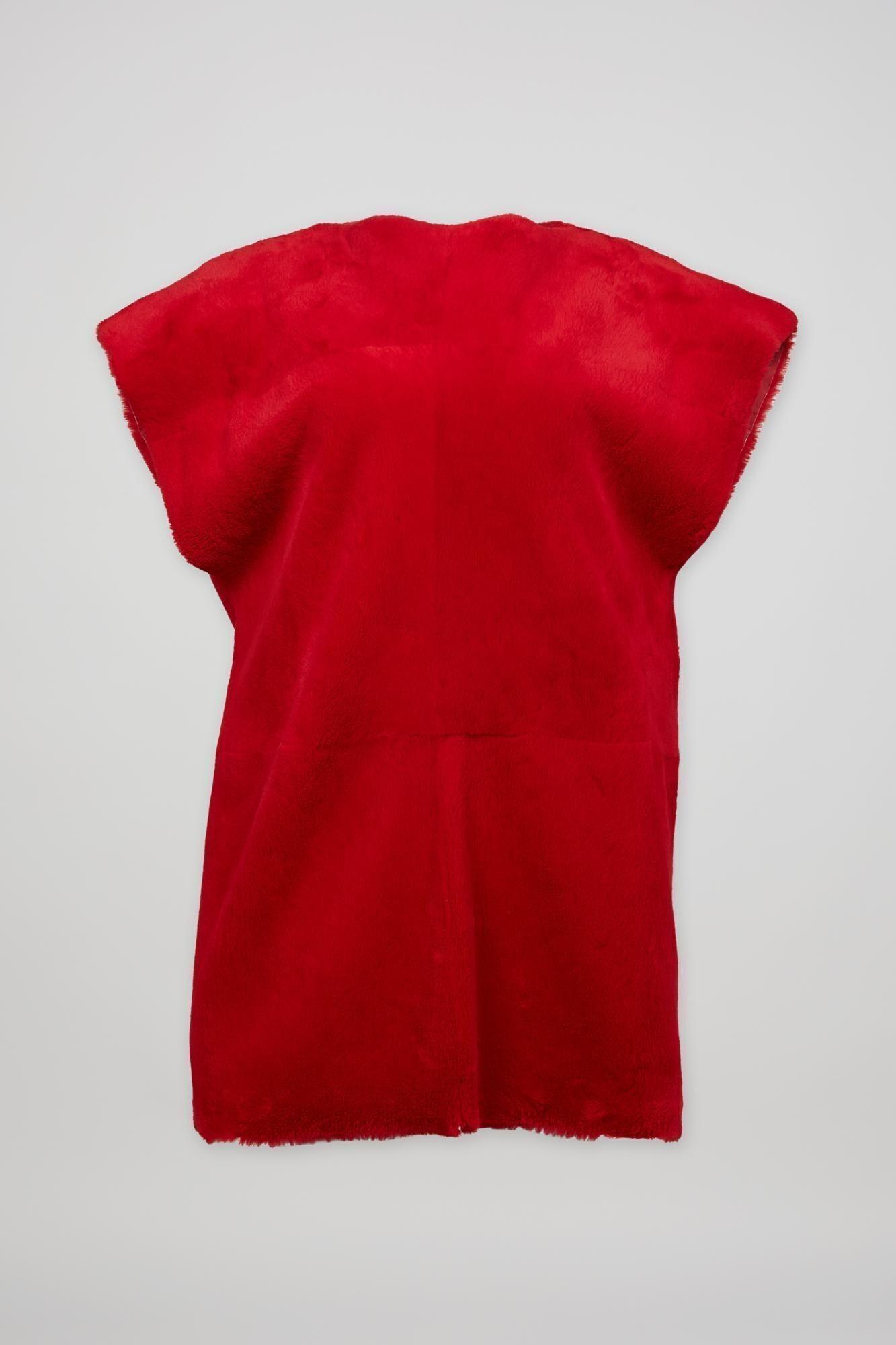 a red shirt is sitting on a white surface .