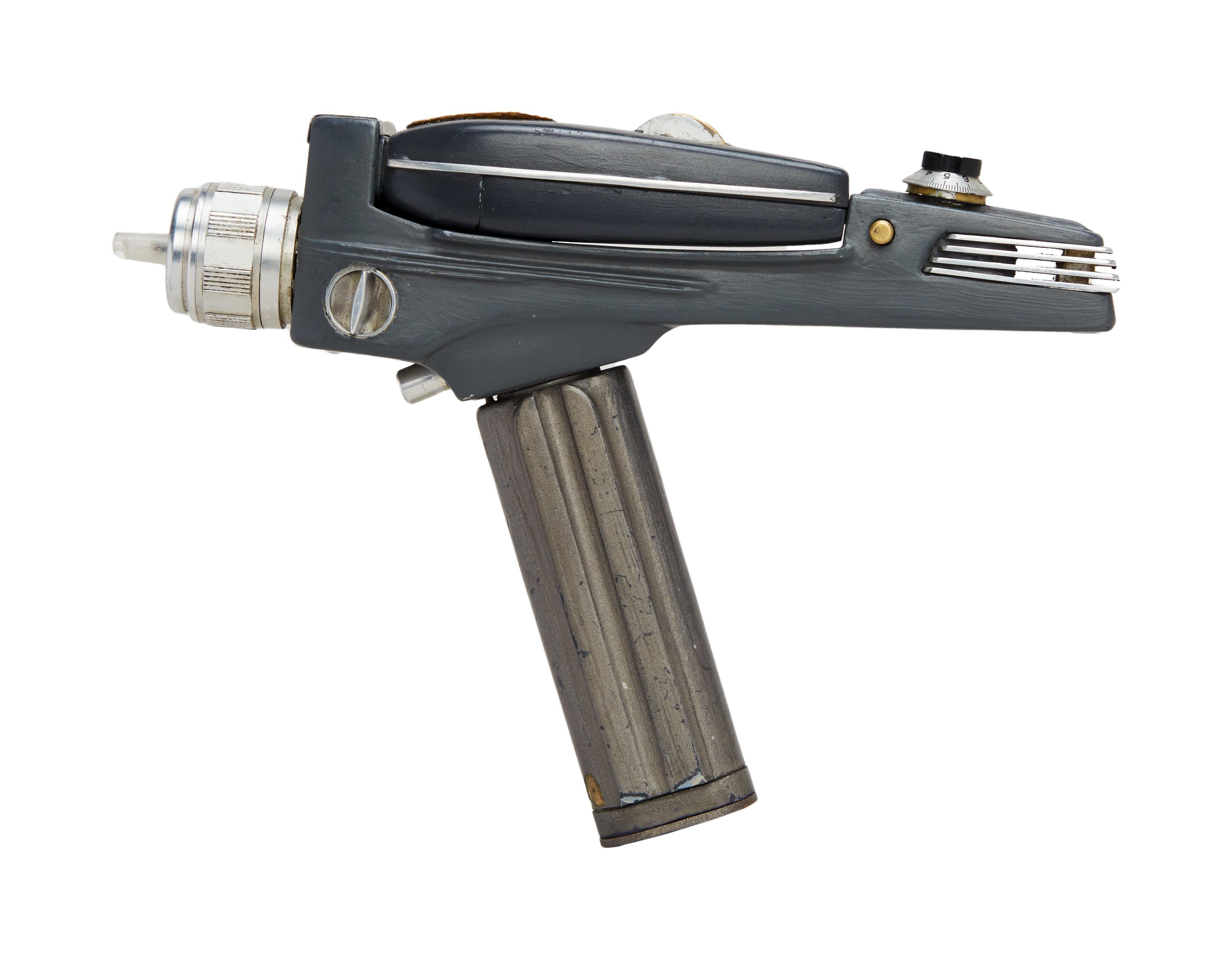 a close up of a star trek phaser on a white background .