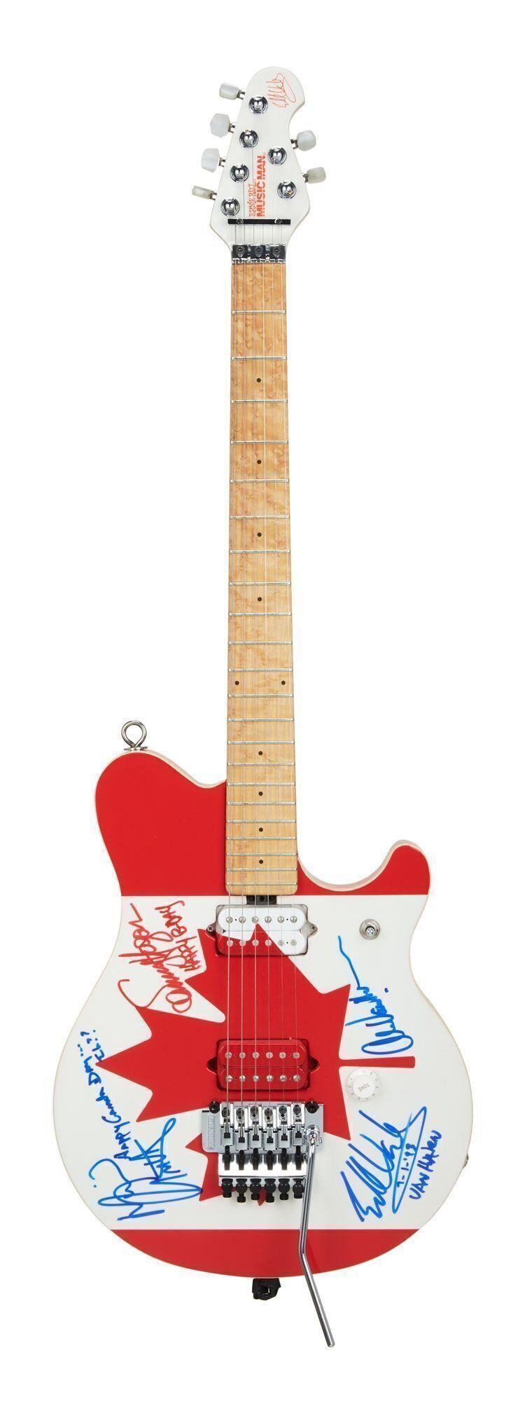 a red white and blue guitar with signatures on it