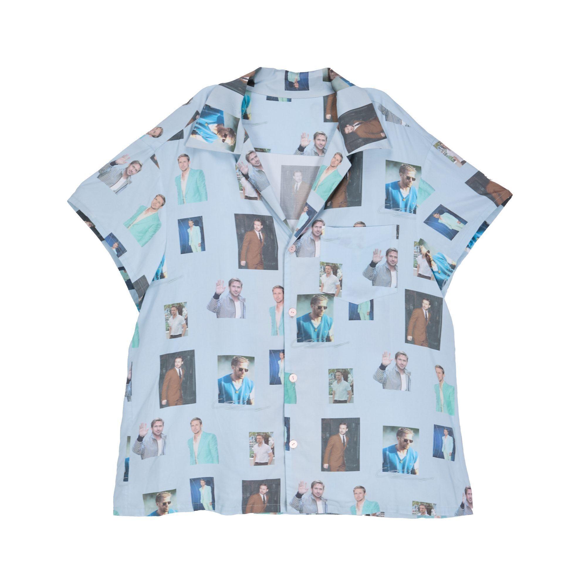 a light blue shirt with many pictures of men on it