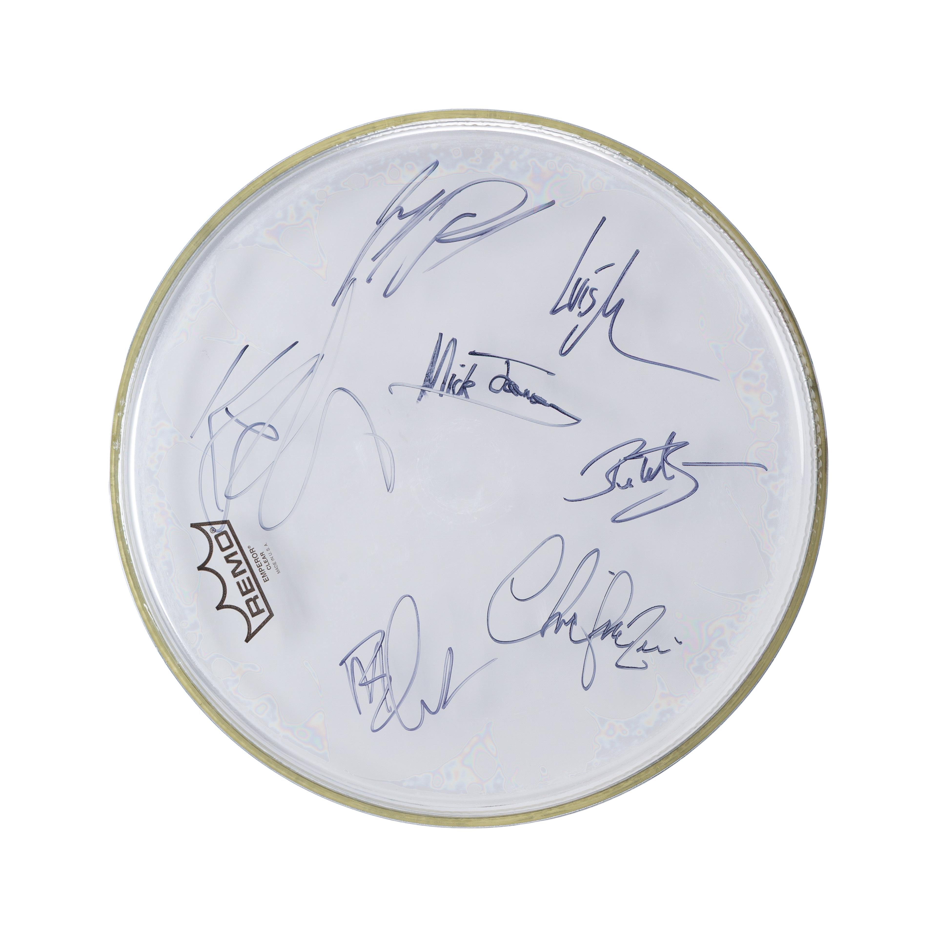 Foreigner | Band-Signed Remo Drum Head White Remo drumhead covered in multiple dark signatures.