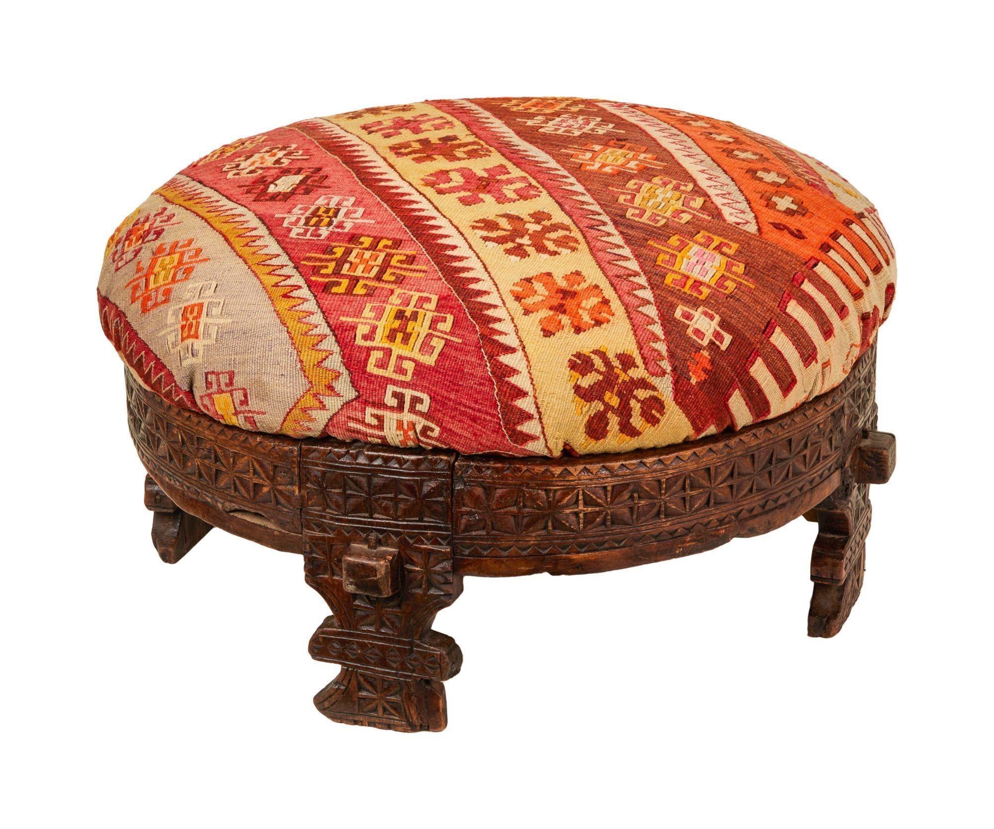a round ottoman with a colorful pattern on it