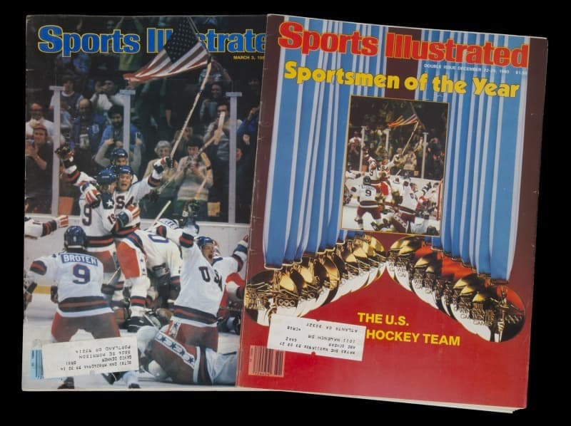 Two Sports Illustrated magazines featuring the 1980 US Olympic Hockey Team; one cover shows them celebrating, the other names them Sportsmen of the Year.