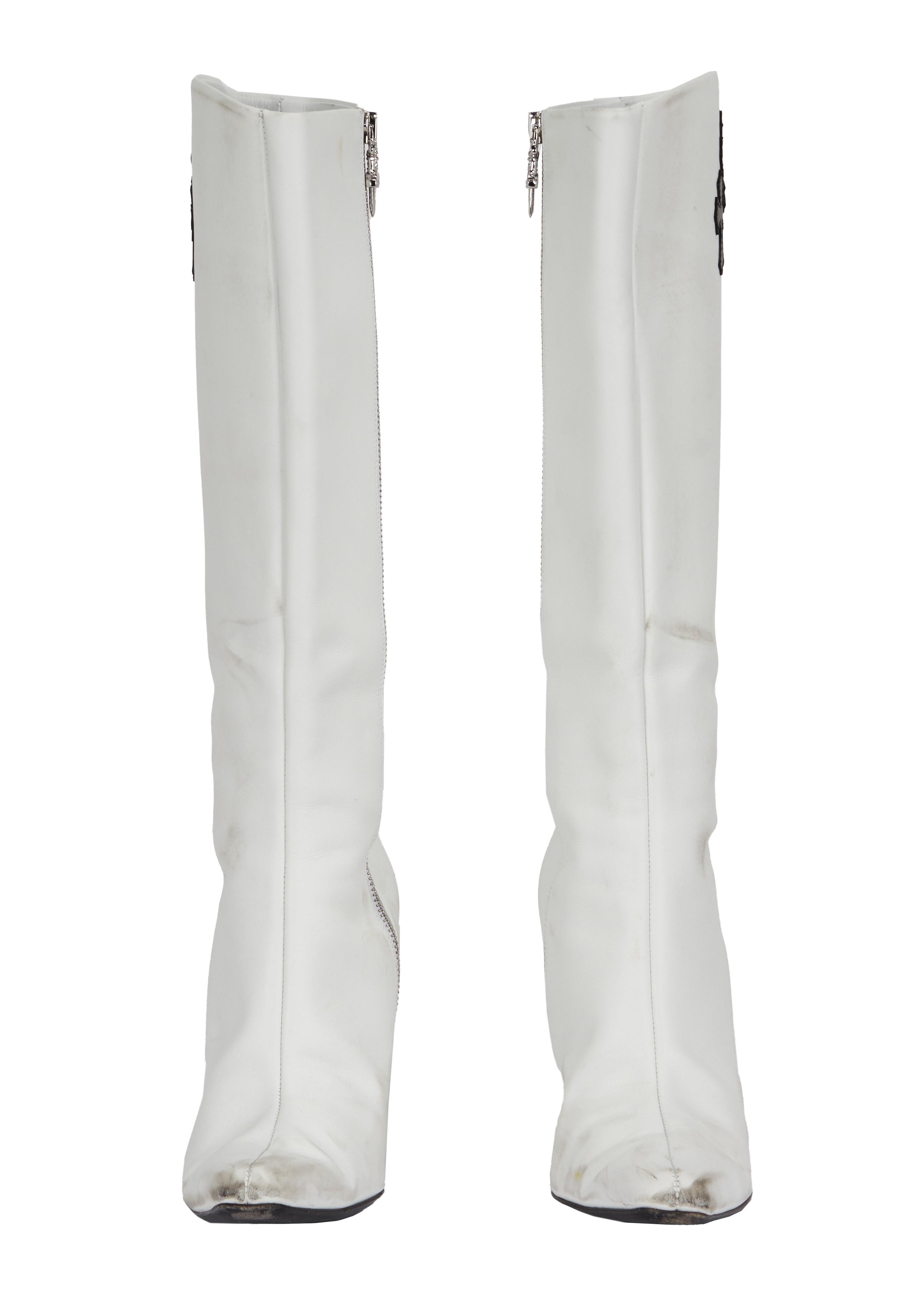 a pair of white boots on a white background