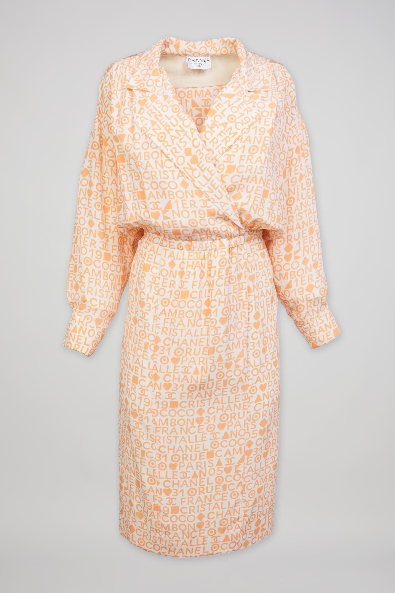 an orange and white chanel dress with long sleeves