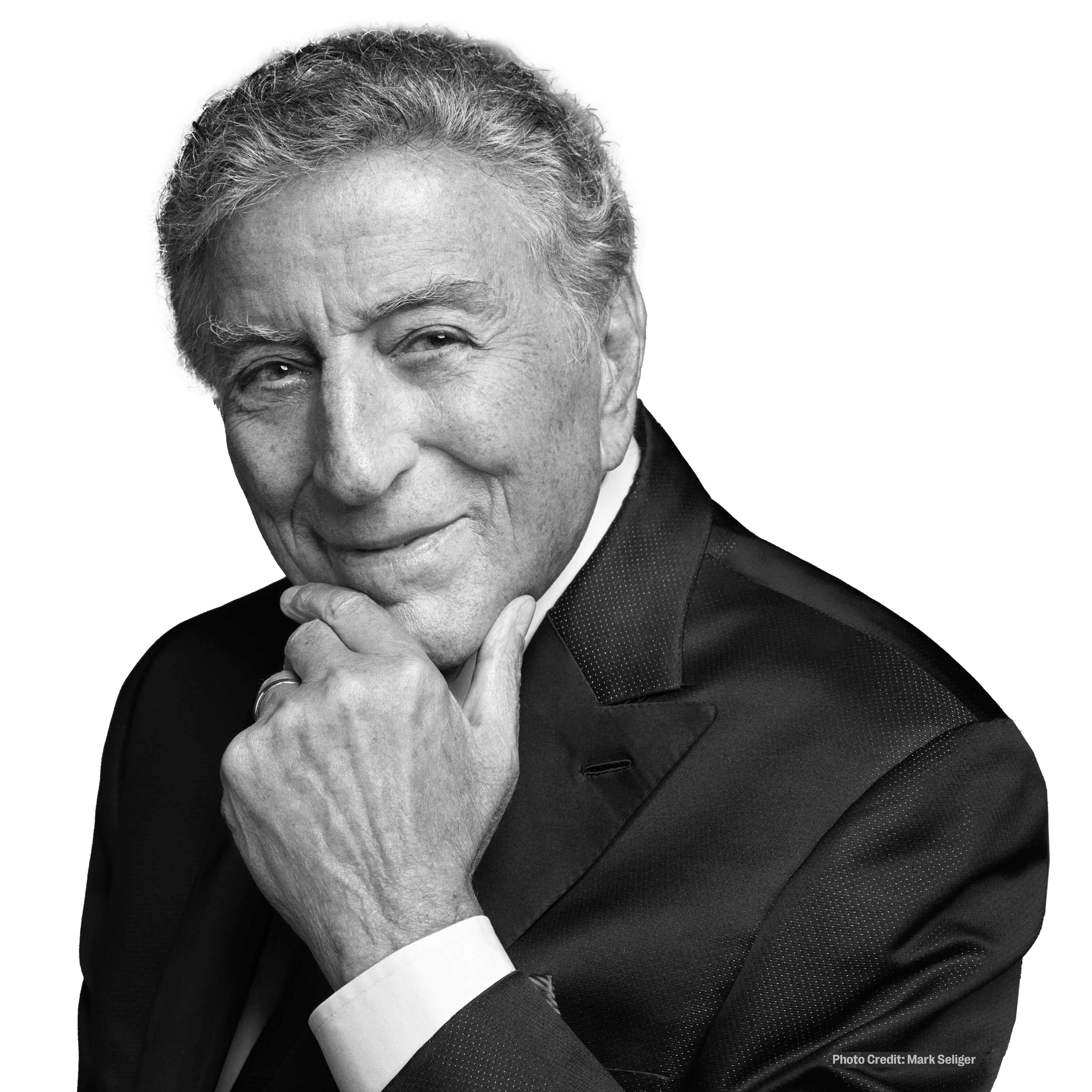 a black and white photo of a man with his hand on his chin