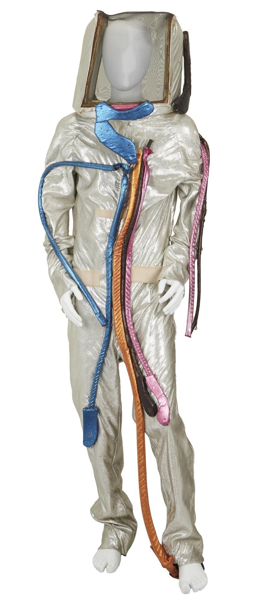 a white mannequin is wearing a silver space suit