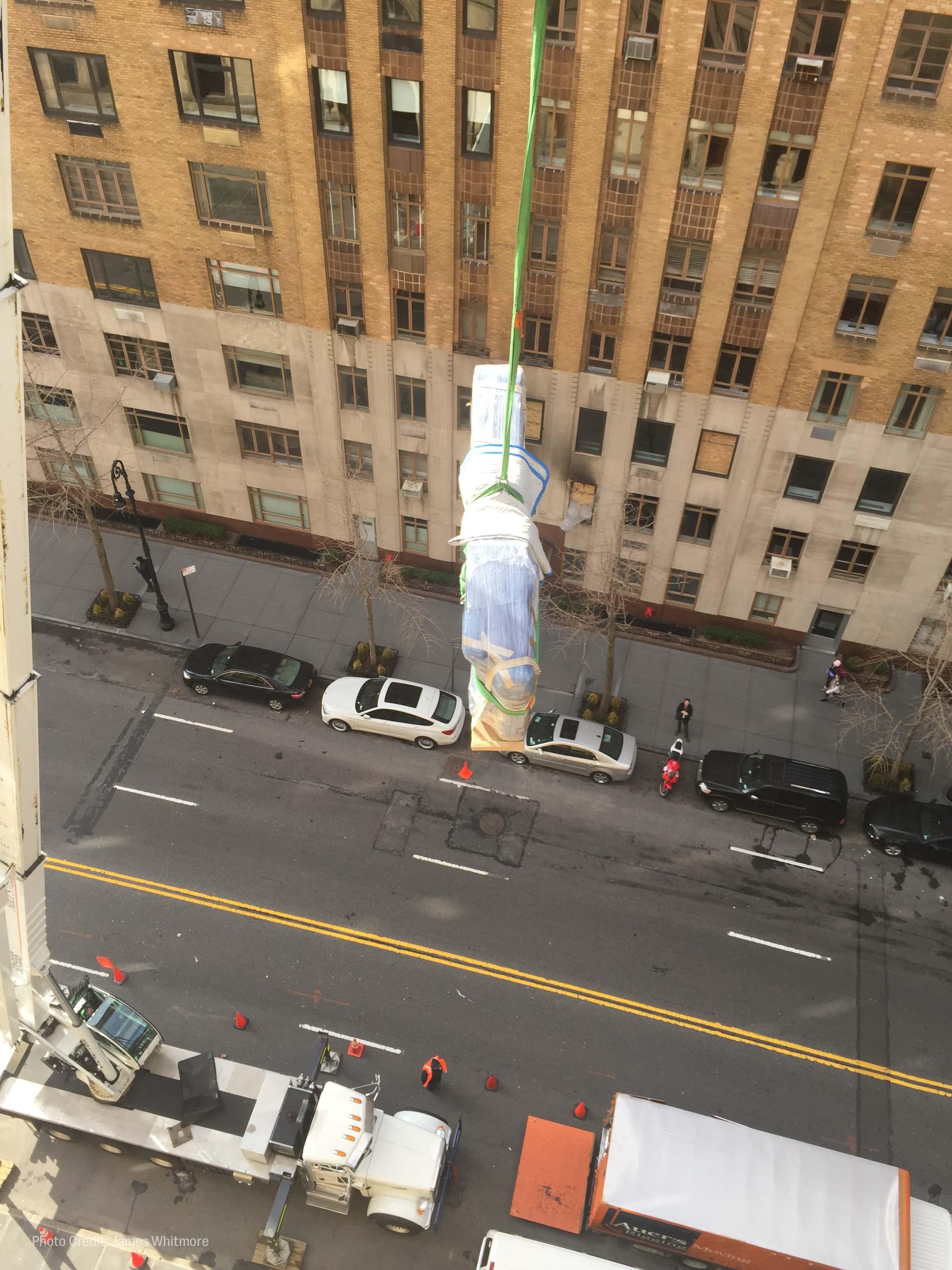 workers hoist roberta flack's piano out of her new york city apartment window.