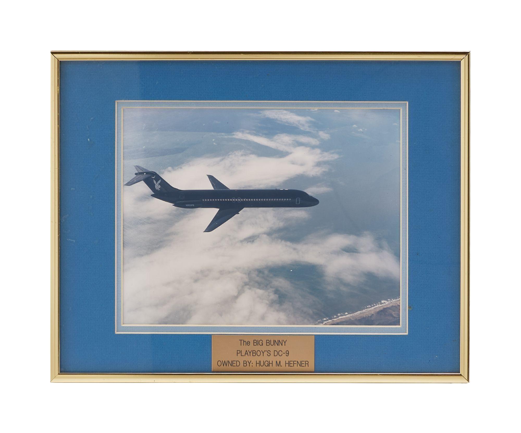 a picture of an airplane flying through the clouds in a blue frame .
