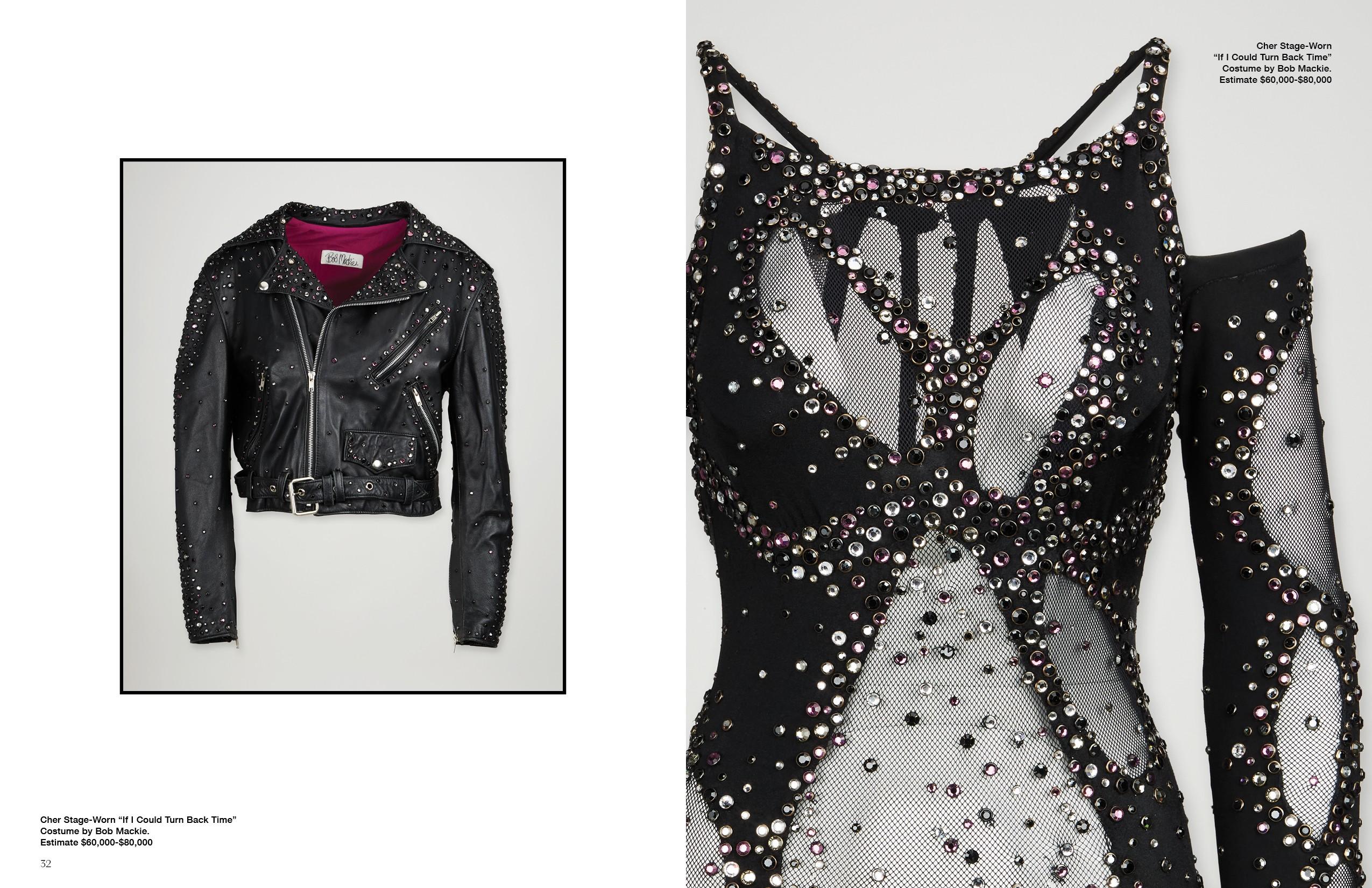a black leather jacket and a black dress are hanging on a wall .