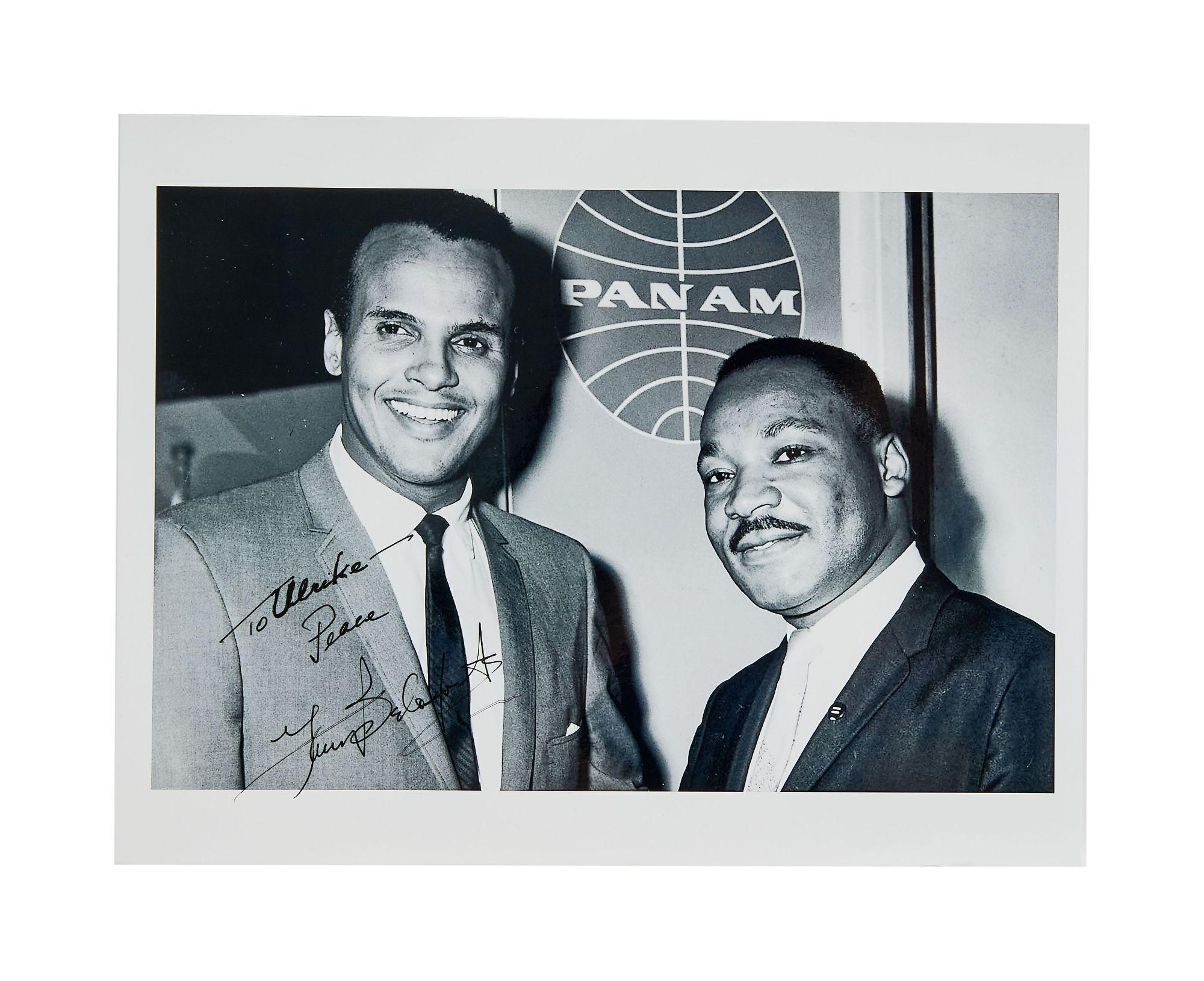Lot #52. Harry Belafonte | Signed Photo with Dr. Martin Luther King, Jr. a black and white photo of two men standing next to each other .